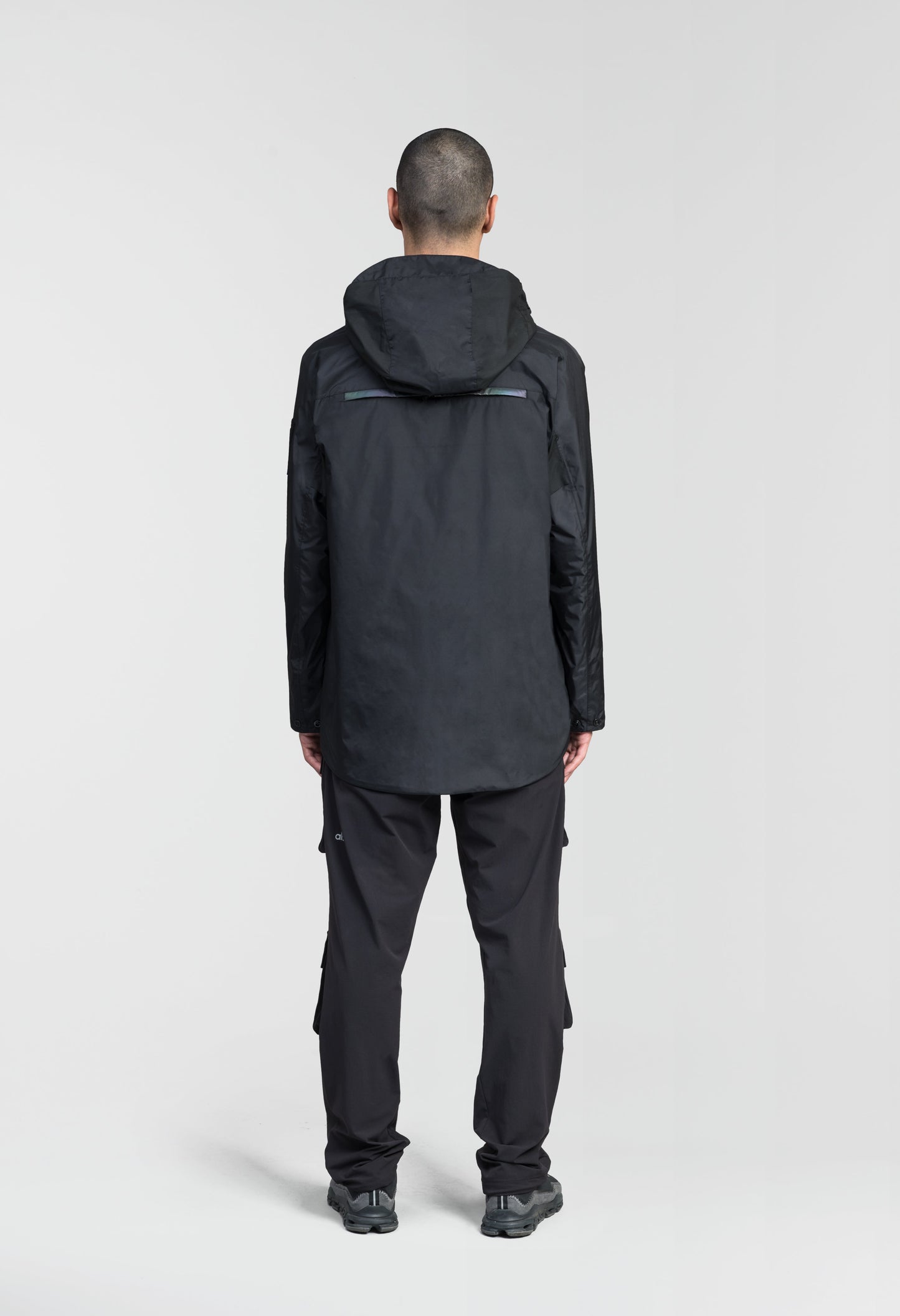 Mission Men's Performance Rain Shell Jacket in hip length, non-removable hood with adjustable toggle, two-way waterproof zipper, flap closure waist pockets with additional side entry storage, zipper ventilation on back, passive underarm ventilation, and breathable mesh lining, in Black