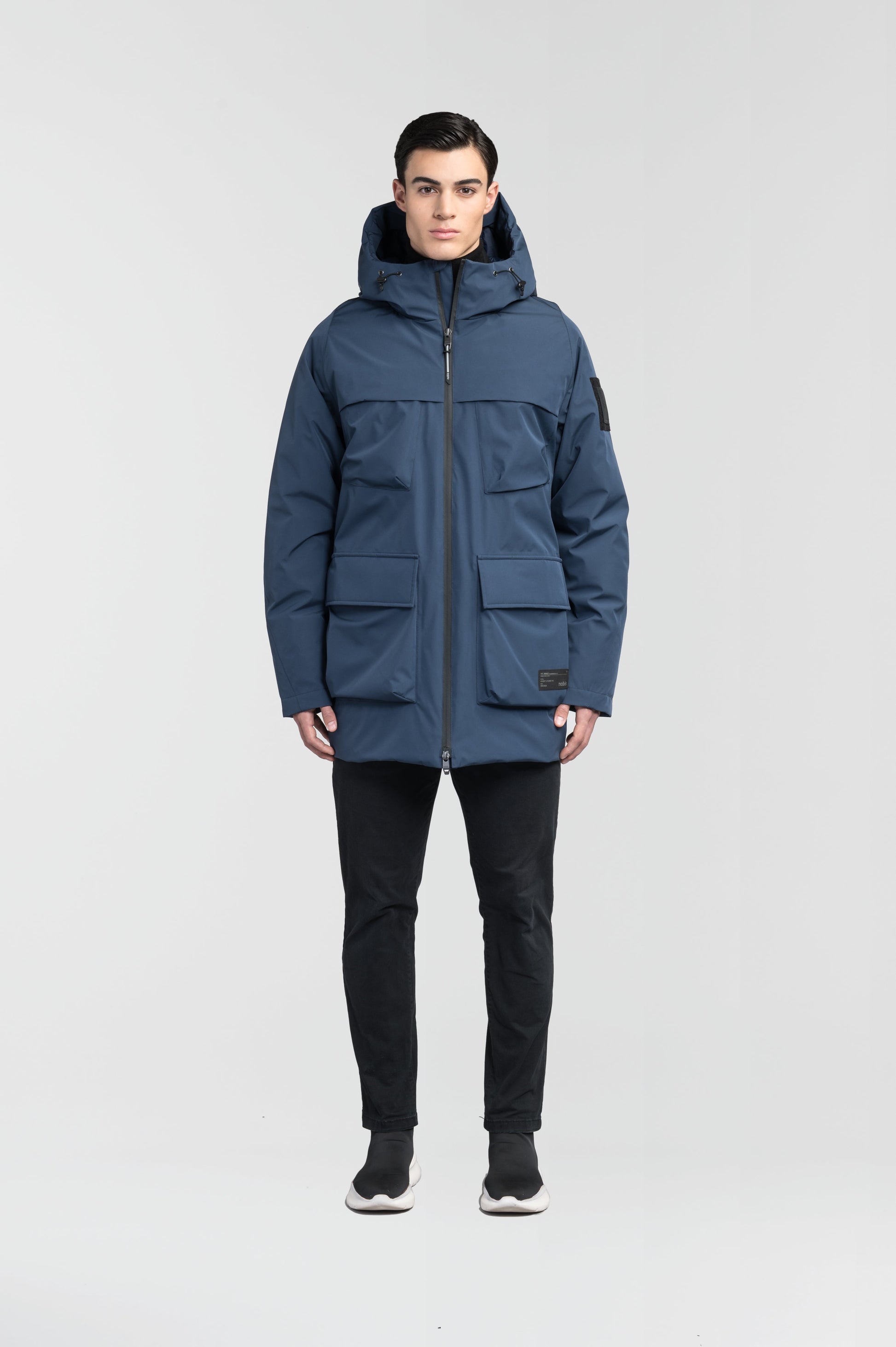 Ronin Men's Performance Utility Jacket in thigh length, premium 3-ply micro denier and stretch ripstop fabrication, Premium Canadian origin White Duck Down insulation, non-removable down-filled hood, bellow chest pockets, magnetic closure waist flap pockets, two-way centre-front zipper, pit zipper vents, hidden adjustable waist drawcord, in Marine