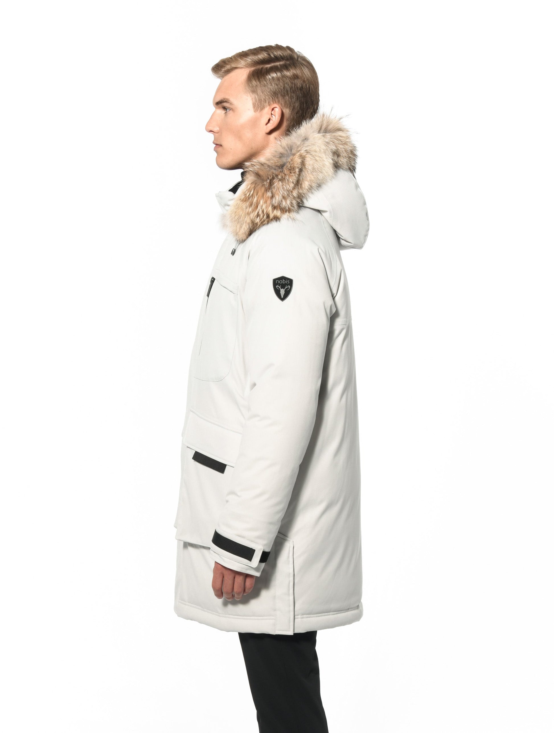 Men's thigh length down-filled parka with removable hood and removable coyote fur trim in Chalk