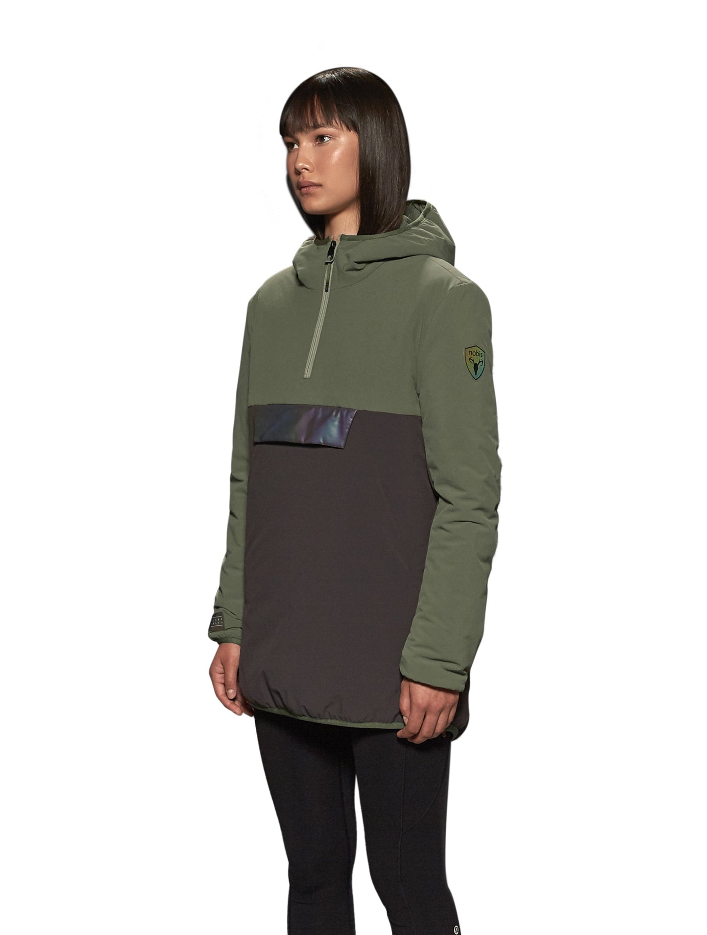 Unisex thigh length hooded anorak with vertical zipper along collar, side zippers along torso, and centre zipper pouch with a reflective flap, in Dusty Olive/Licorice