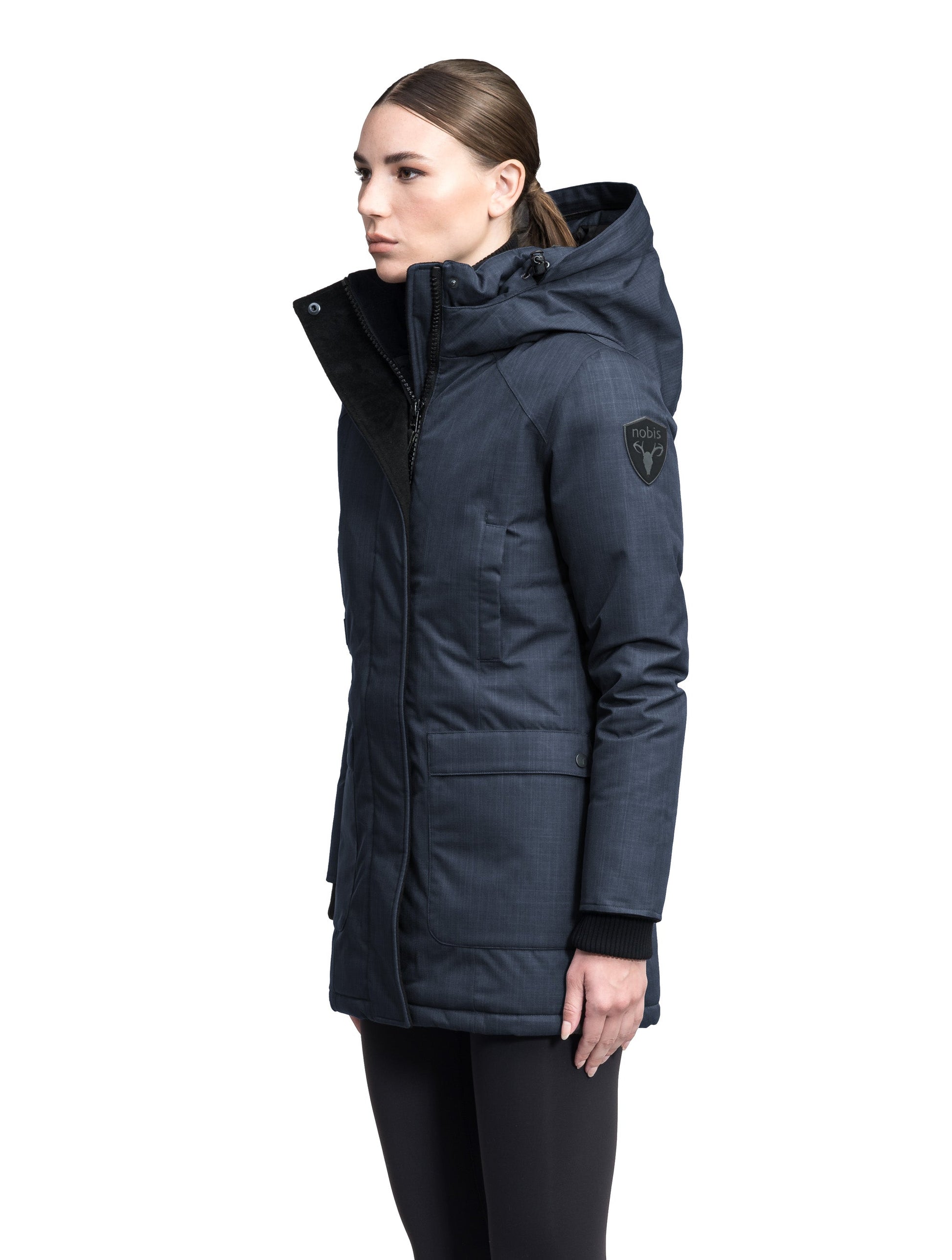 Carla Furless Ladies Parka in thigh length with Canadian Premium White Duck Down insulation, non-removable hood, centre-front zipper with magnetic closure wind flap, and four exterior pockets, in Navy