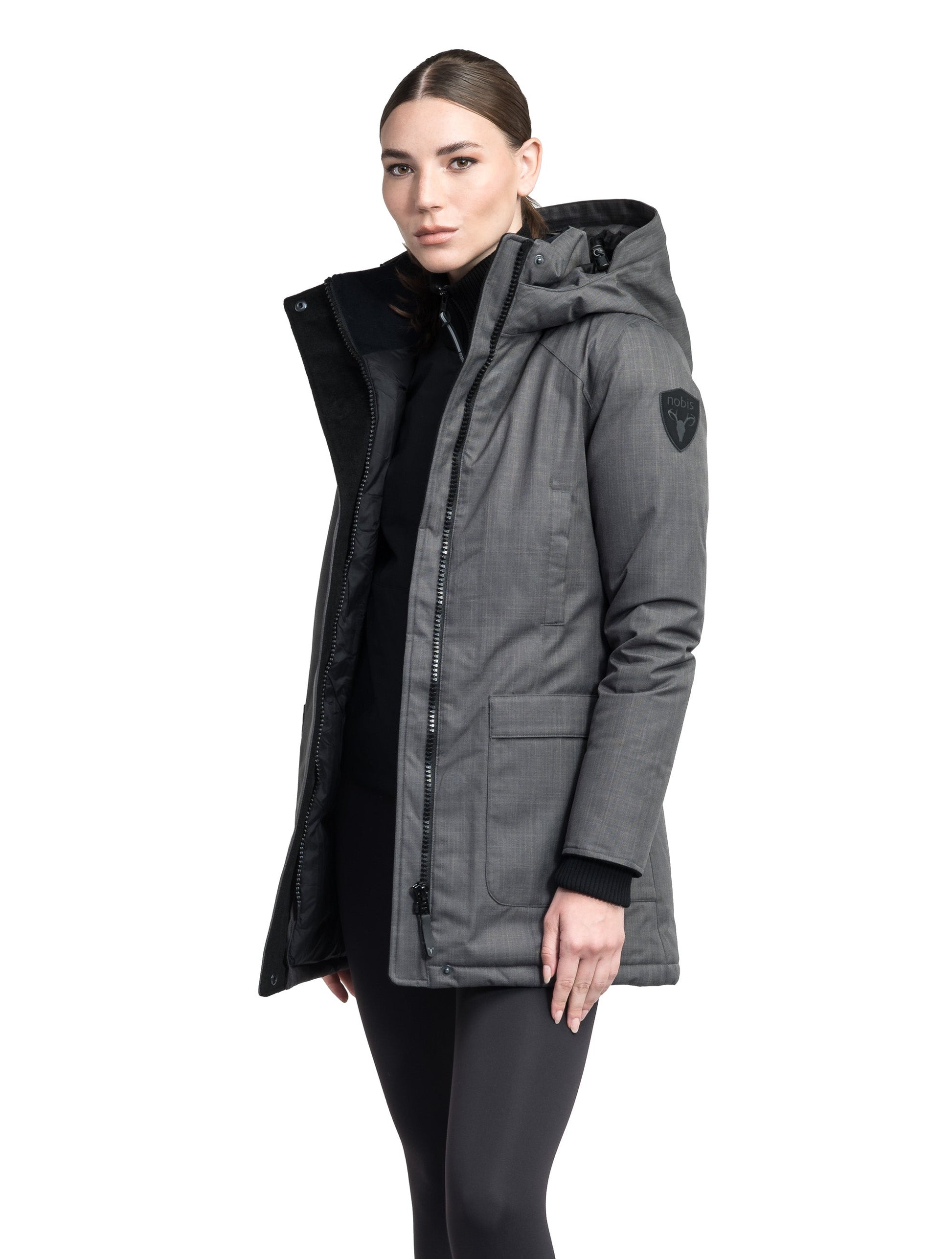 Carla Furless Ladies Parka in thigh length with Canadian Premium White Duck Down insulation, non-removable hood, centre-front zipper with magnetic closure wind flap, and four exterior pockets, in Steel Grey