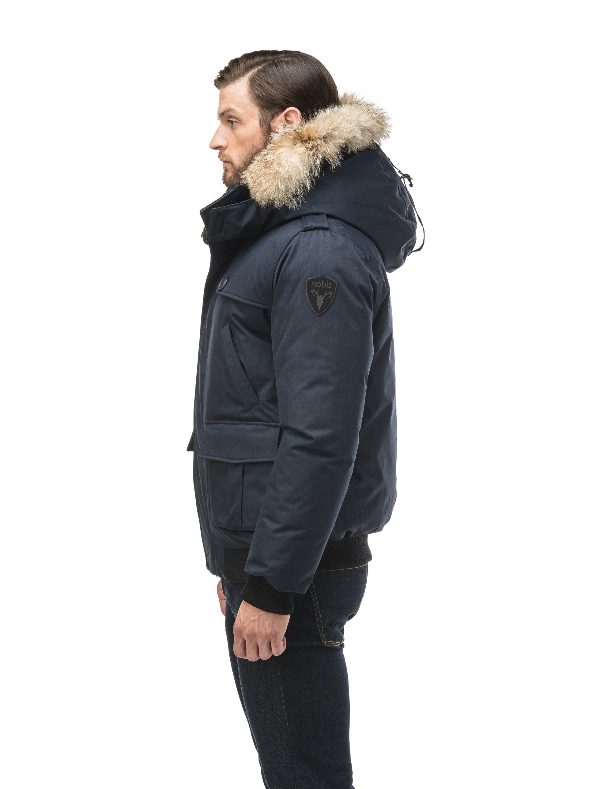 Men's down filled bomber that sits just above the hips with a completely removable hood that's windproof, waterproof, and breathable in CH Navy