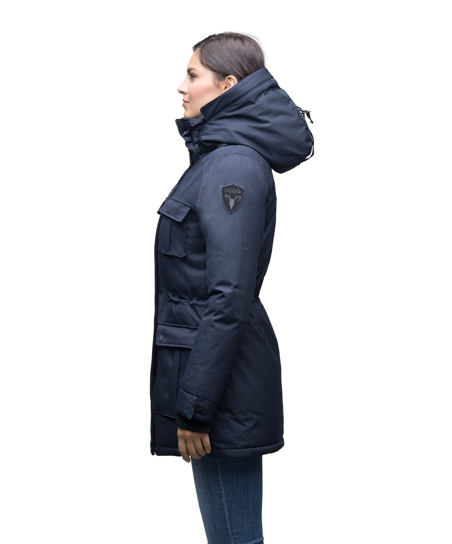 Women's down filled thigh length parka with four pleated patch pockets and an adjustable waist in CH Navy