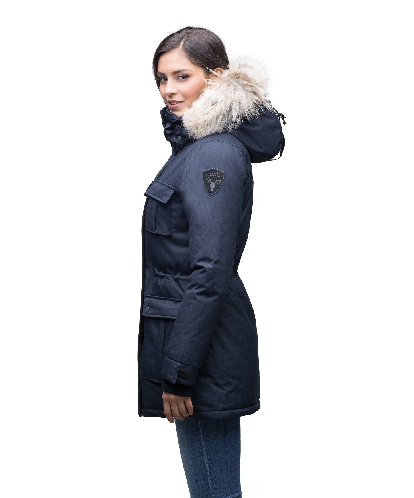 Women's down filled thigh length parka with four pleated patch pockets and an adjustable waist in CH Navy