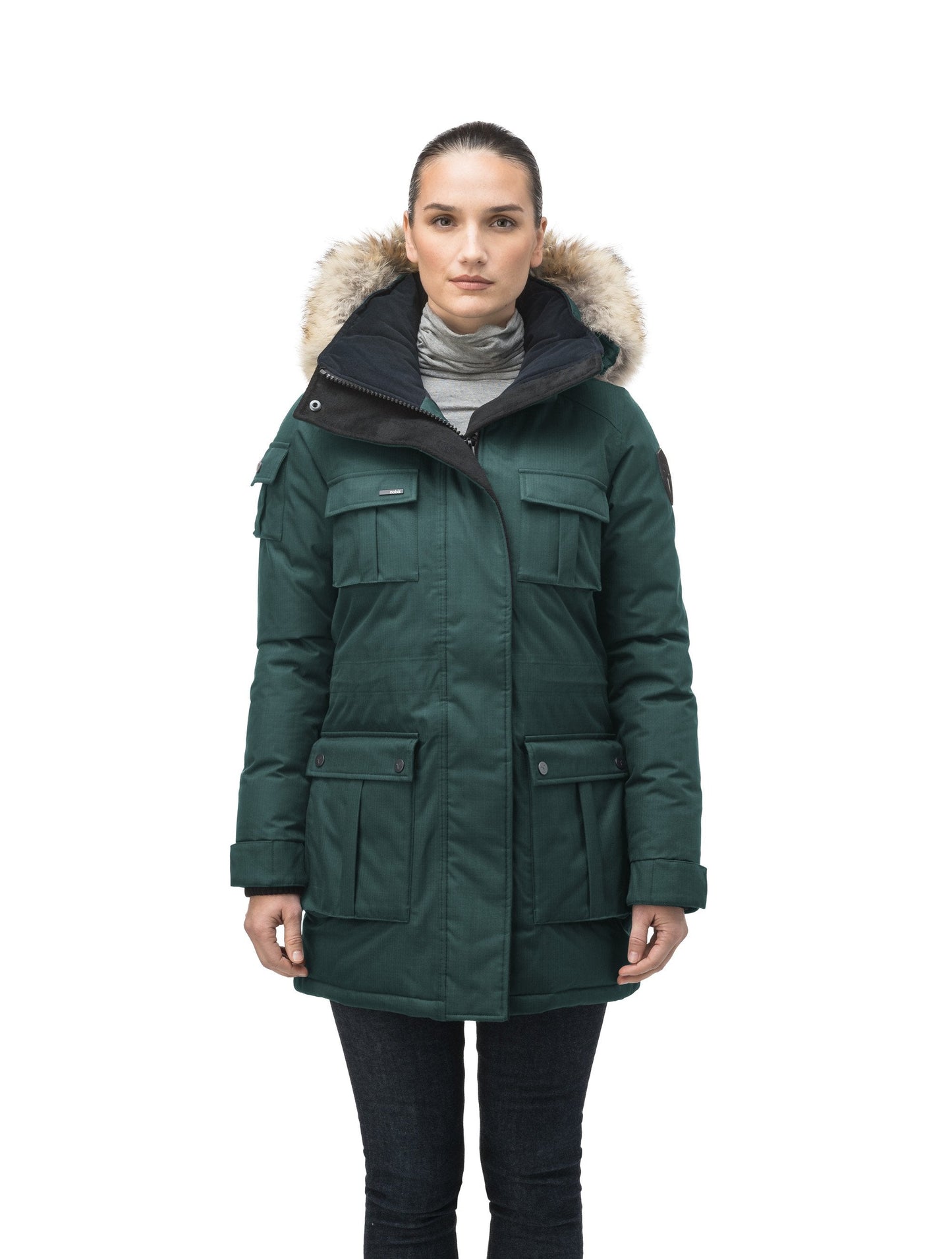 Women's down filled thigh length parka with four pleated patch pockets and an adjustable waist in CH Forest