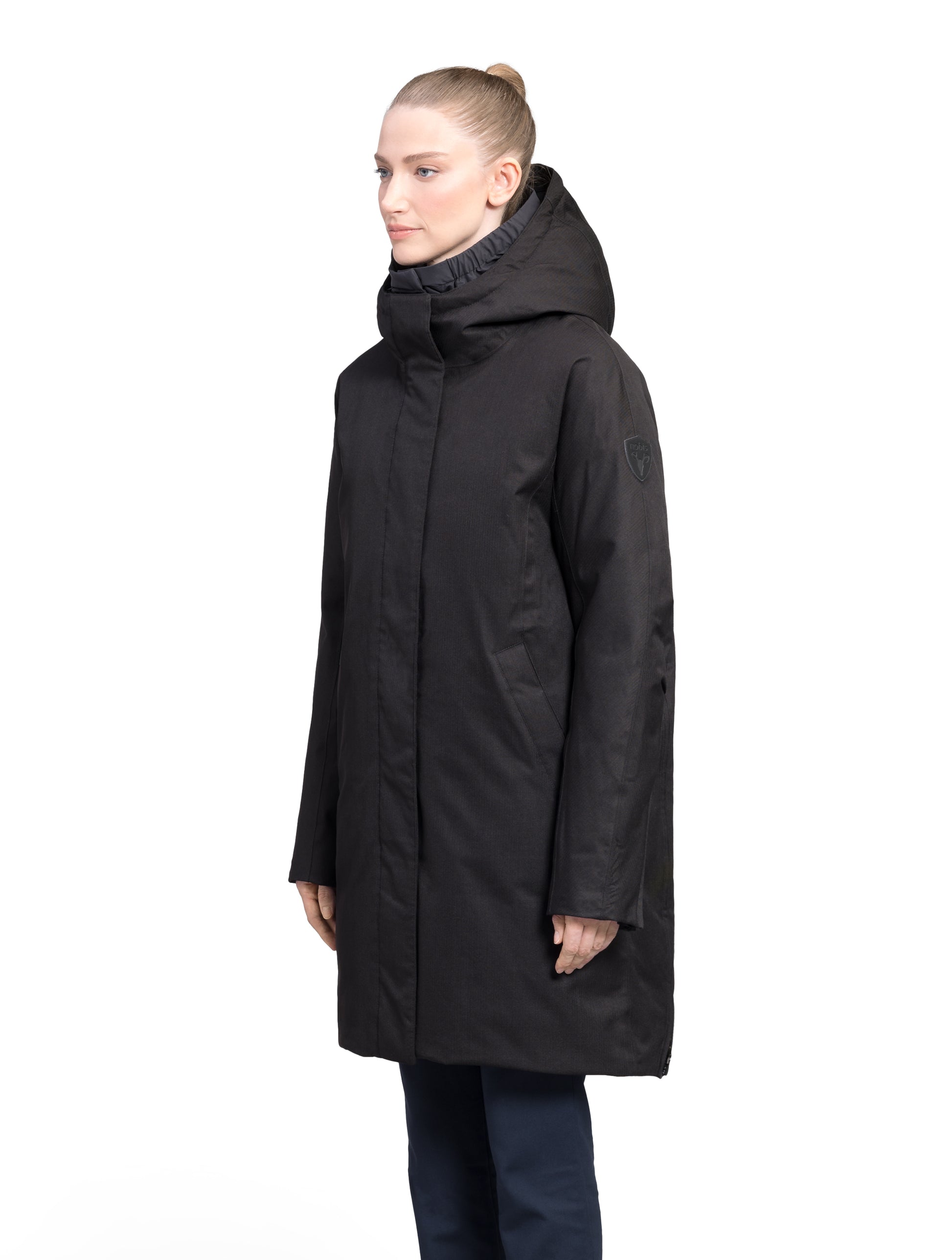 Dory Women's Tailored Back Zip Parka in knee length, premium Crosshatch fabrication, Premium Canadian White Duck Down insulation, non-removable down-filled hood, removable interior hood, centre front two-way zipper with wind flap, vertical zipper detailing along back, in Black
