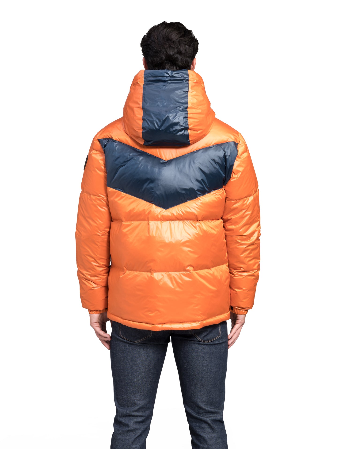 Dyna Men's Chevron Quilted Puffer Jacket in hip length, premium cire technical nylon taffeta fabrication, Premium Canadian origin White Duck Down insulation, non-removable down-filled hood, two-way centre-front zipper, fleece-lined zipper pockets at waist, pit zipper vents, in Burnt Orange