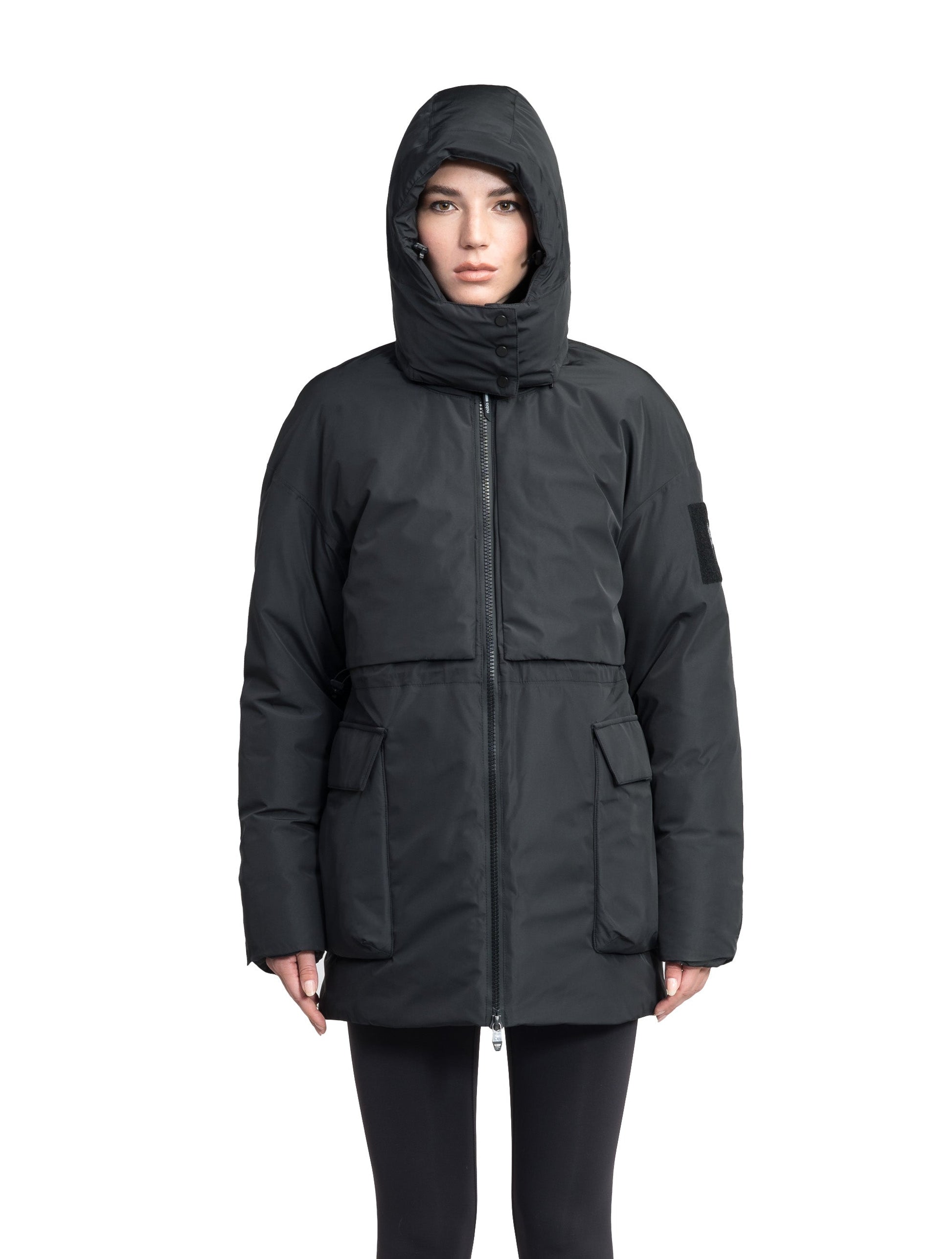 Haelyn Ladies Short Utility Parka in thigh length, 3-Ply Micro Denier fabrication, Premium Canadian White Duck Down insulation, removable down-filled hood, two-way centre front zipper, hidden adjustable cord at waist, adjustable snap cuffs, and four exterior patch pockets at front, in Black