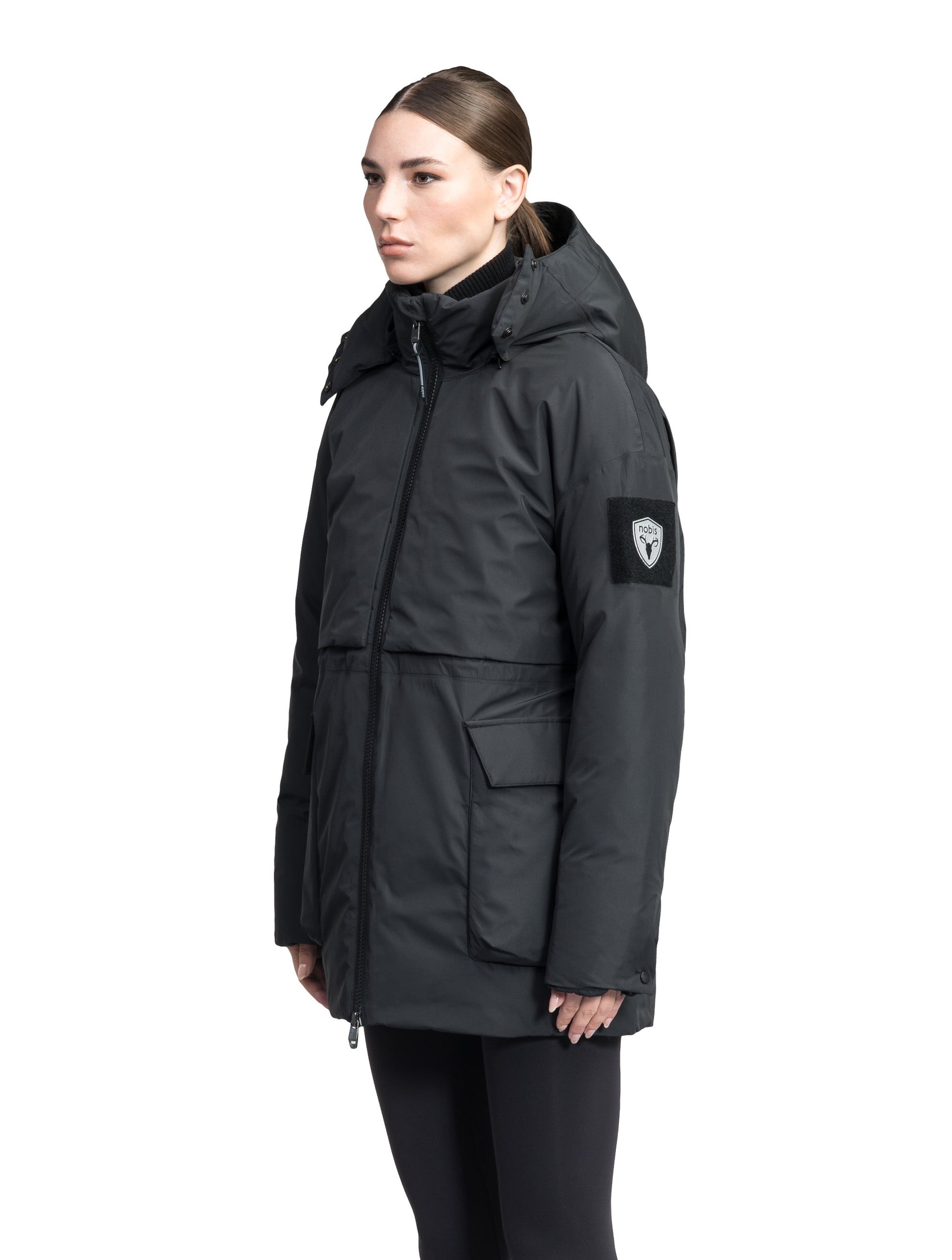 Haelyn Ladies Short Utility Parka in thigh length, 3-Ply Micro Denier fabrication, Premium Canadian White Duck Down insulation, removable down-filled hood, two-way centre front zipper, hidden adjustable cord at waist, adjustable snap cuffs, and four exterior patch pockets at front, in Black