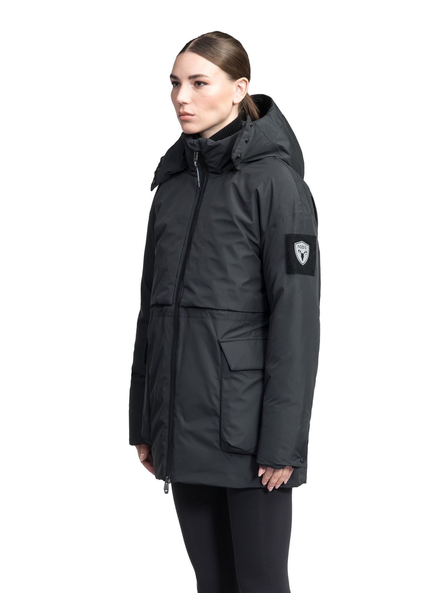 Haelyn Ladies Short Utility Parka in thigh length, 3-Ply Micro Denier fabrication, Premium Canadian White Duck Down insulation, removable down-filled hood, two-way centre front zipper, hidden adjustable cord at waist, adjustable snap cuffs, and four exterior patch pockets at front, in Black