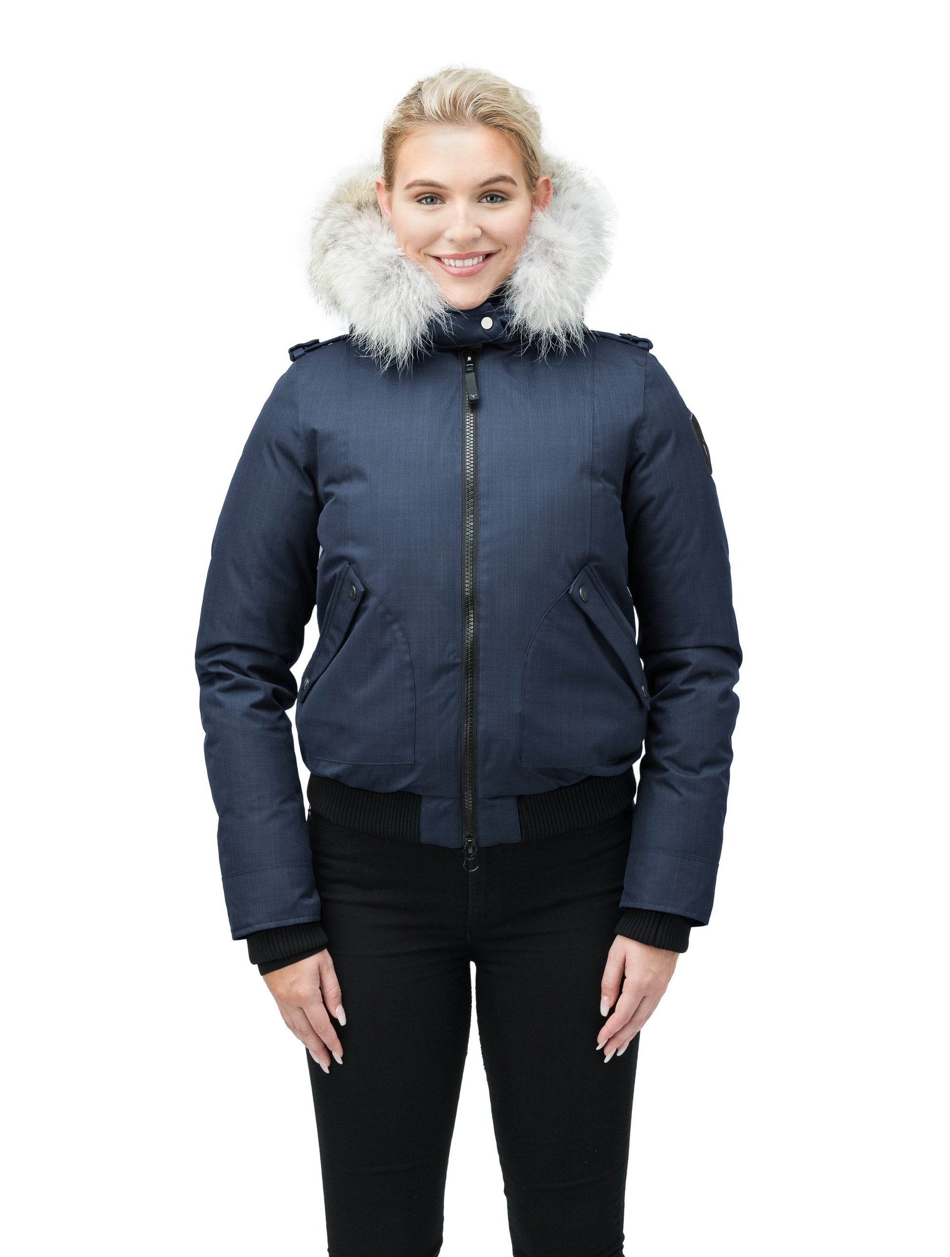 Women's bomber style down filled jacket with a removable hood and fur trim in CH Navy