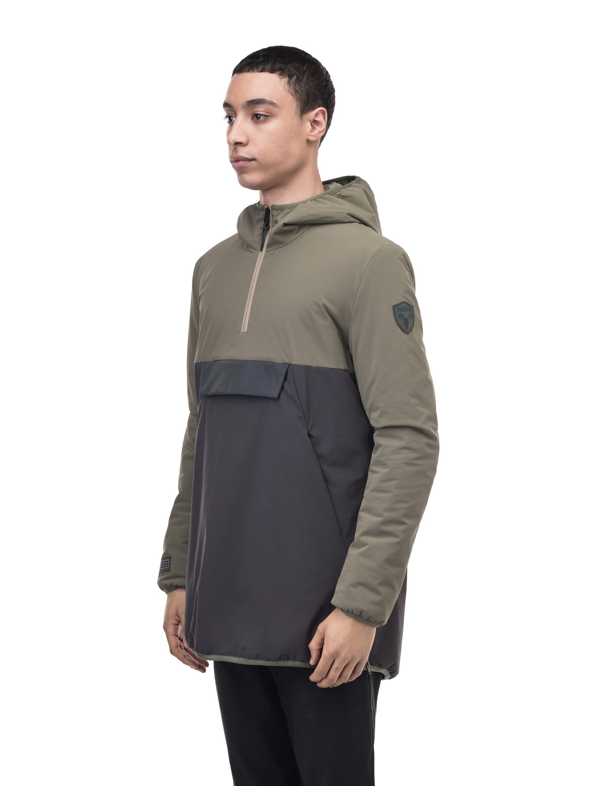 Unisex thigh length hooded anorak with vertical zipper along collar, side zippers along torso, and centre zipper pouch with a reflective flap, in Dusty Olive/Licorice