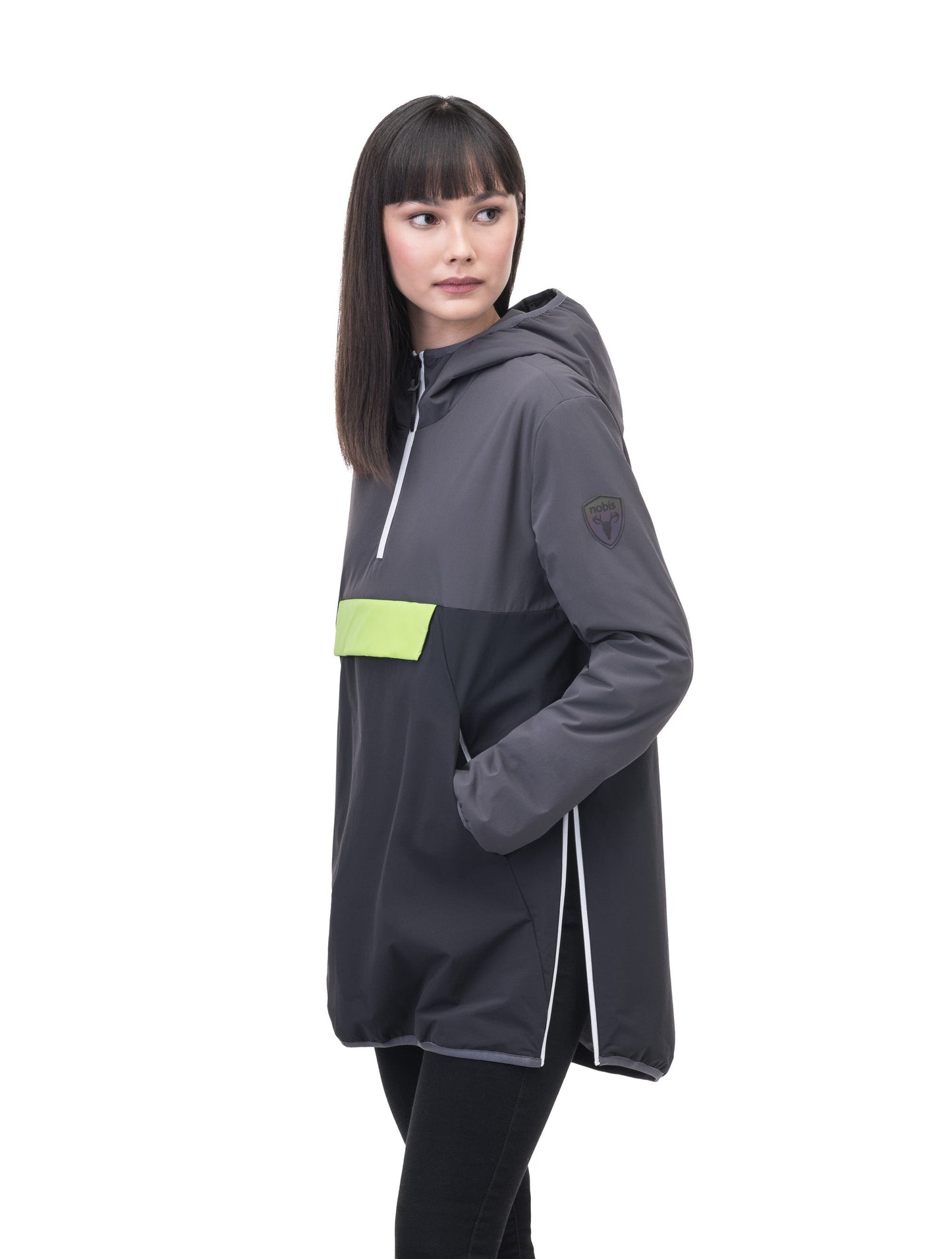 Unisex thigh length hooded anorak with vertical zipper along collar, side zippers along torso, and centre zipper pouch with a reflective flap, in Steel Grey/Black