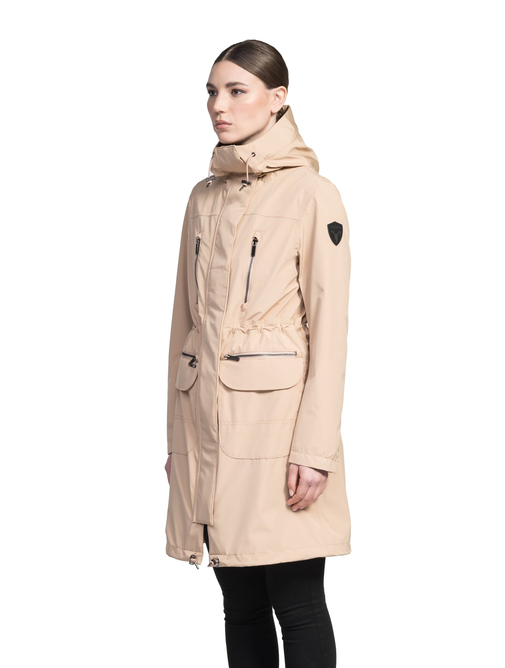 Women's knee length anorak with four front pockets and adjustable cord waist in Fawn