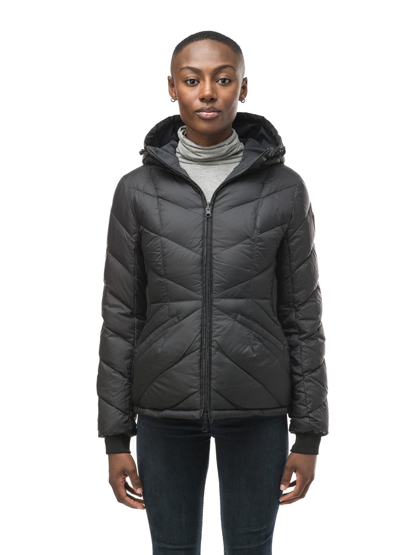 A women's two in one reversible hip length down jacket, one side is quilted and one side is solid waterproof fabric in Black