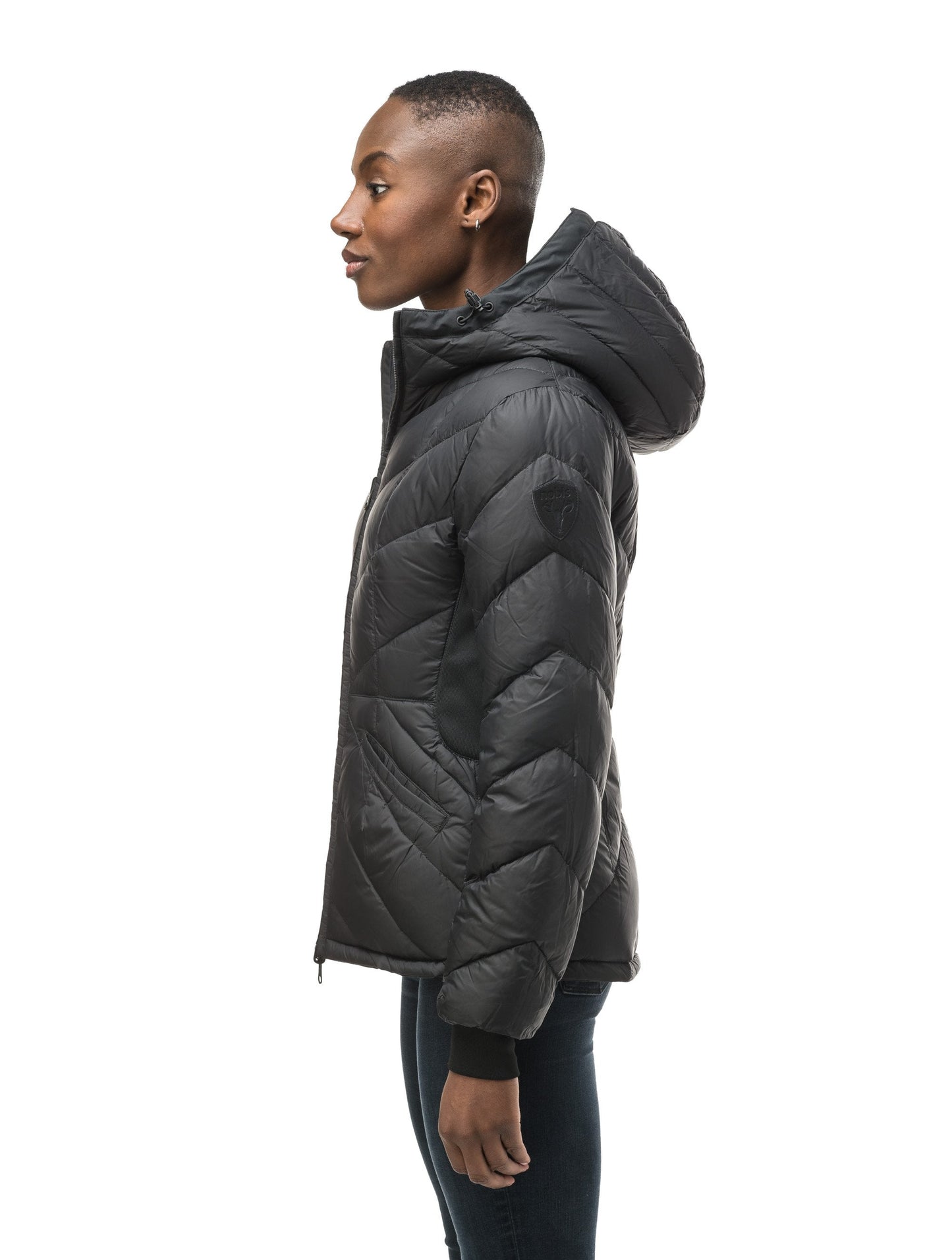 A women's two in one reversible hip length down jacket, one side is quilted and one side is solid waterproof fabric in Black