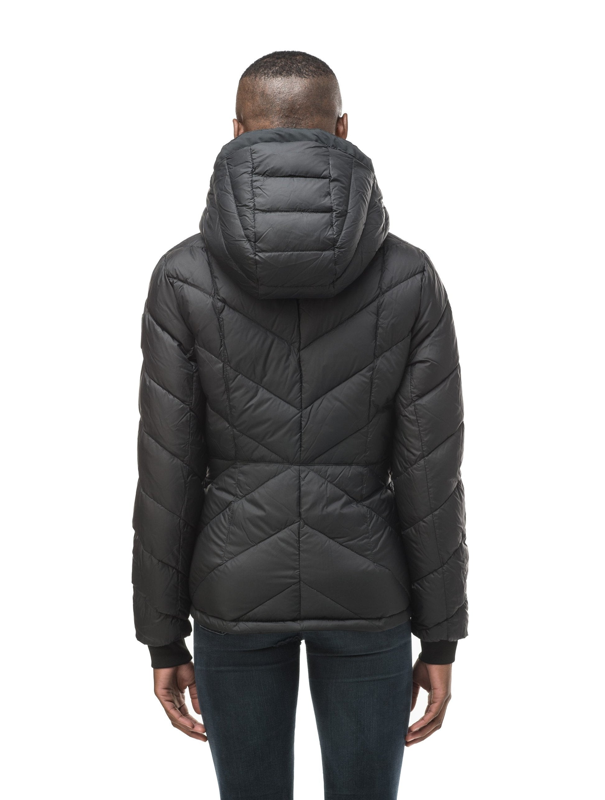 A women's two in one reversible hip length down jacket, one side is quilted and one side is solid waterproof fabric in Black