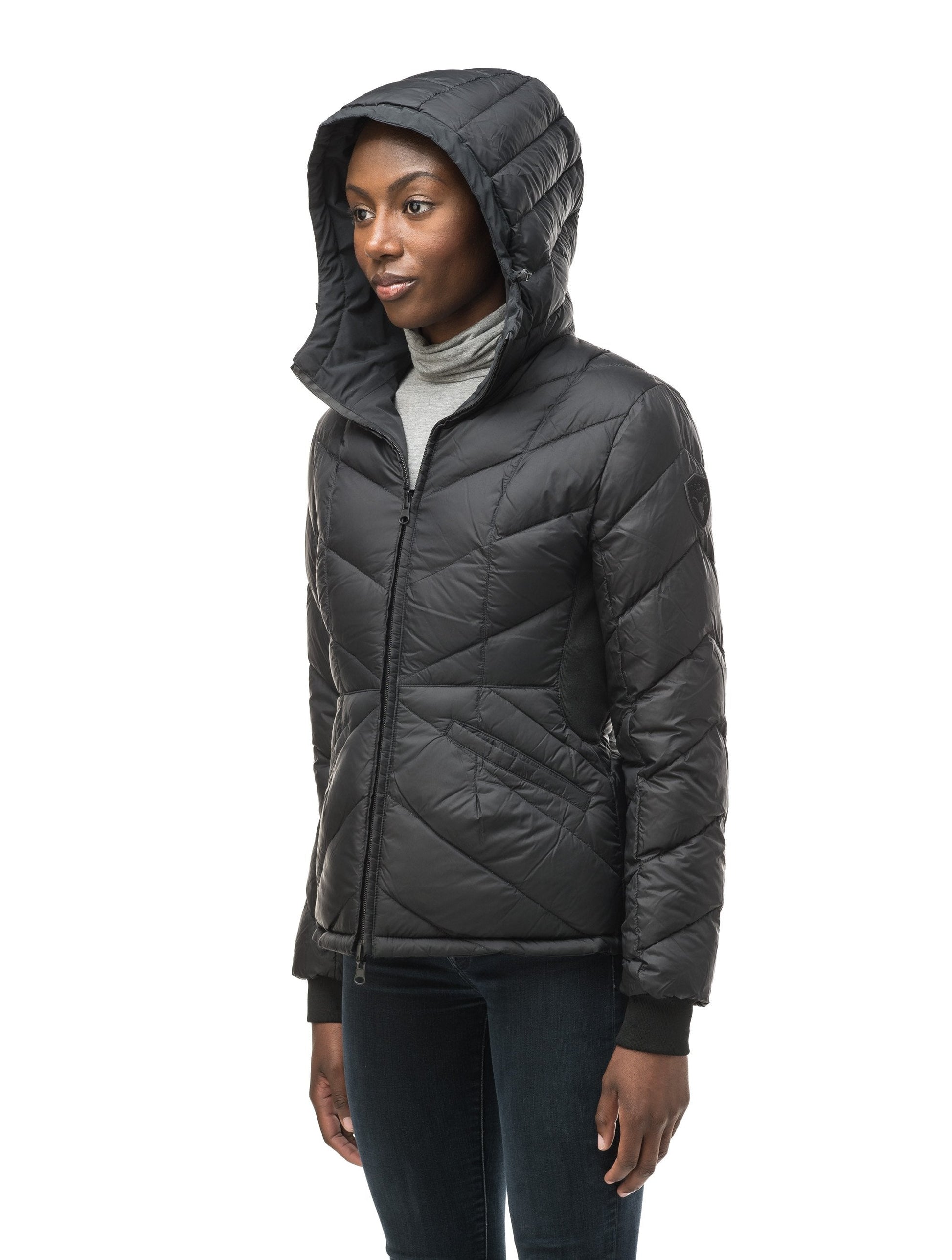 A women's two in one reversible hip length down jacket, one side is quilted and one side is solid waterproof fabric in Black