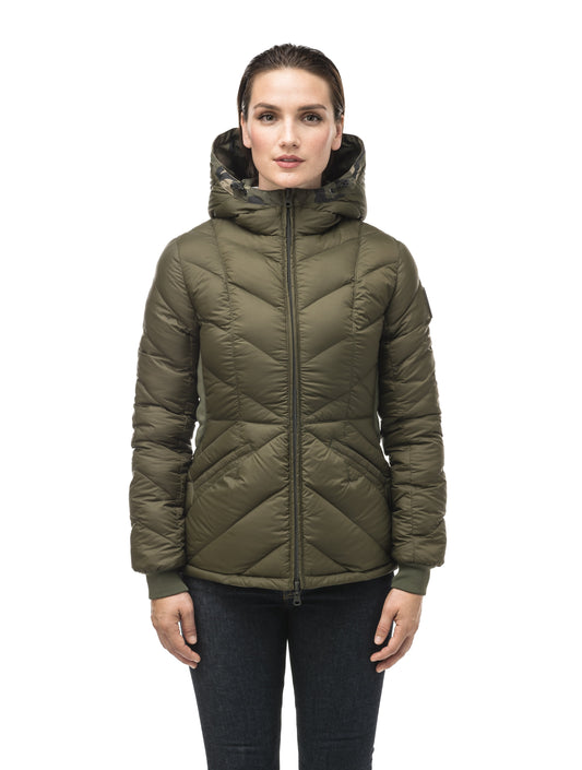A women's two in one reversible hip length down jacket, one side is quilted and one side is solid waterproof fabric in Camo + Camo