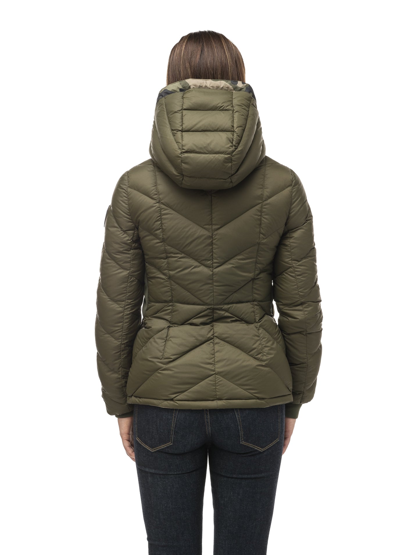 A women's two in one reversible hip length down jacket, one side is quilted and one side is solid waterproof fabric in Camo