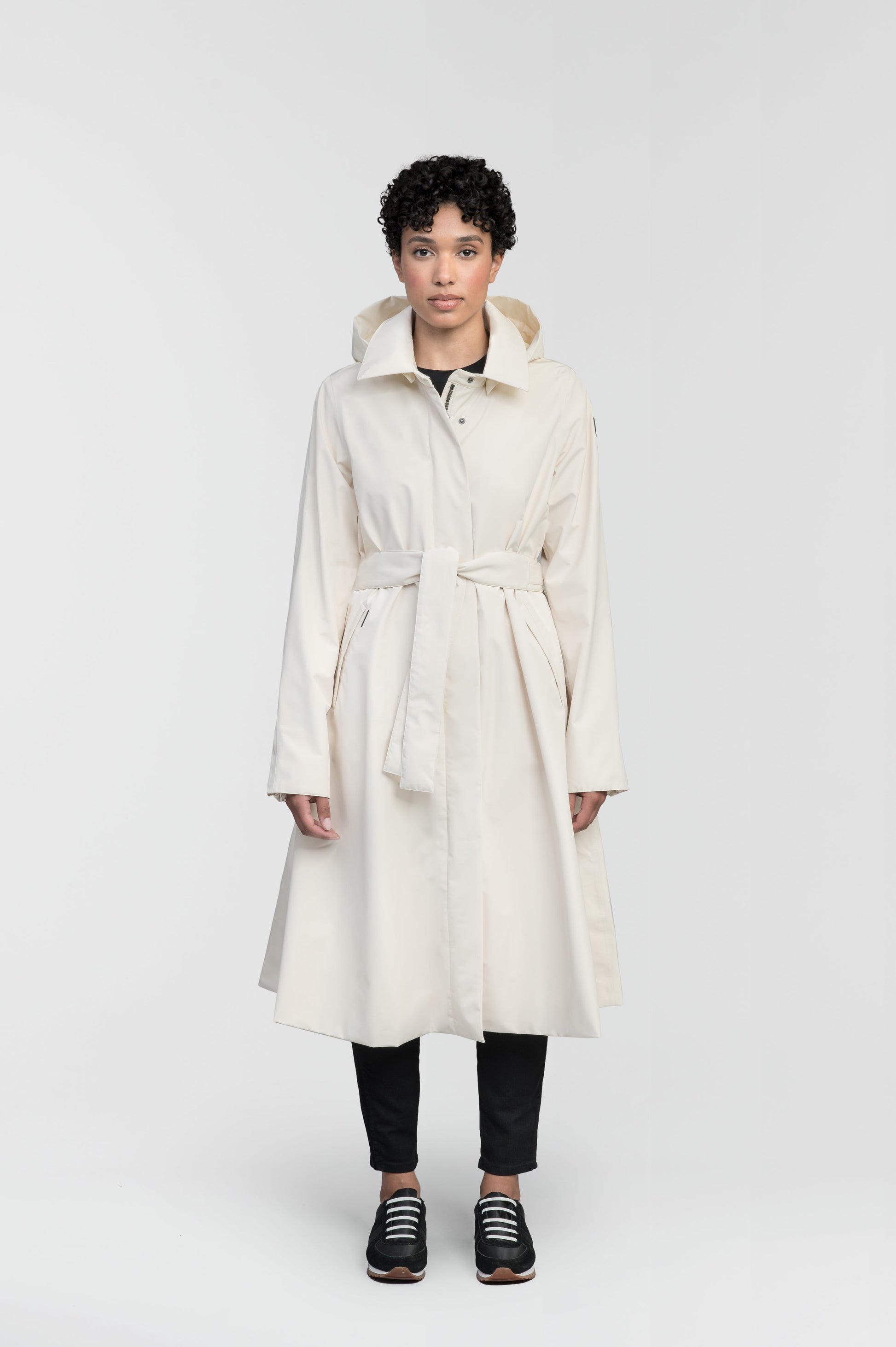 Ivy Ladies Tailored Trench Coat in knee length, 3-Ply Micro Denier fabrication, retractable non-removable hood, front wind flap with snap button closure, removable belt, and adjustable snap cuffs, in Wheat