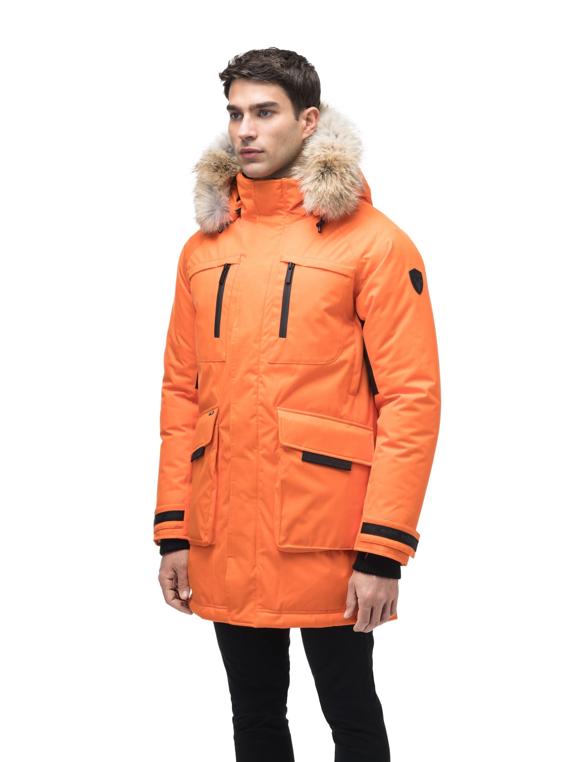 Men's thigh length down-filled parka with removable hood and removable coyote fur trim in Atomic