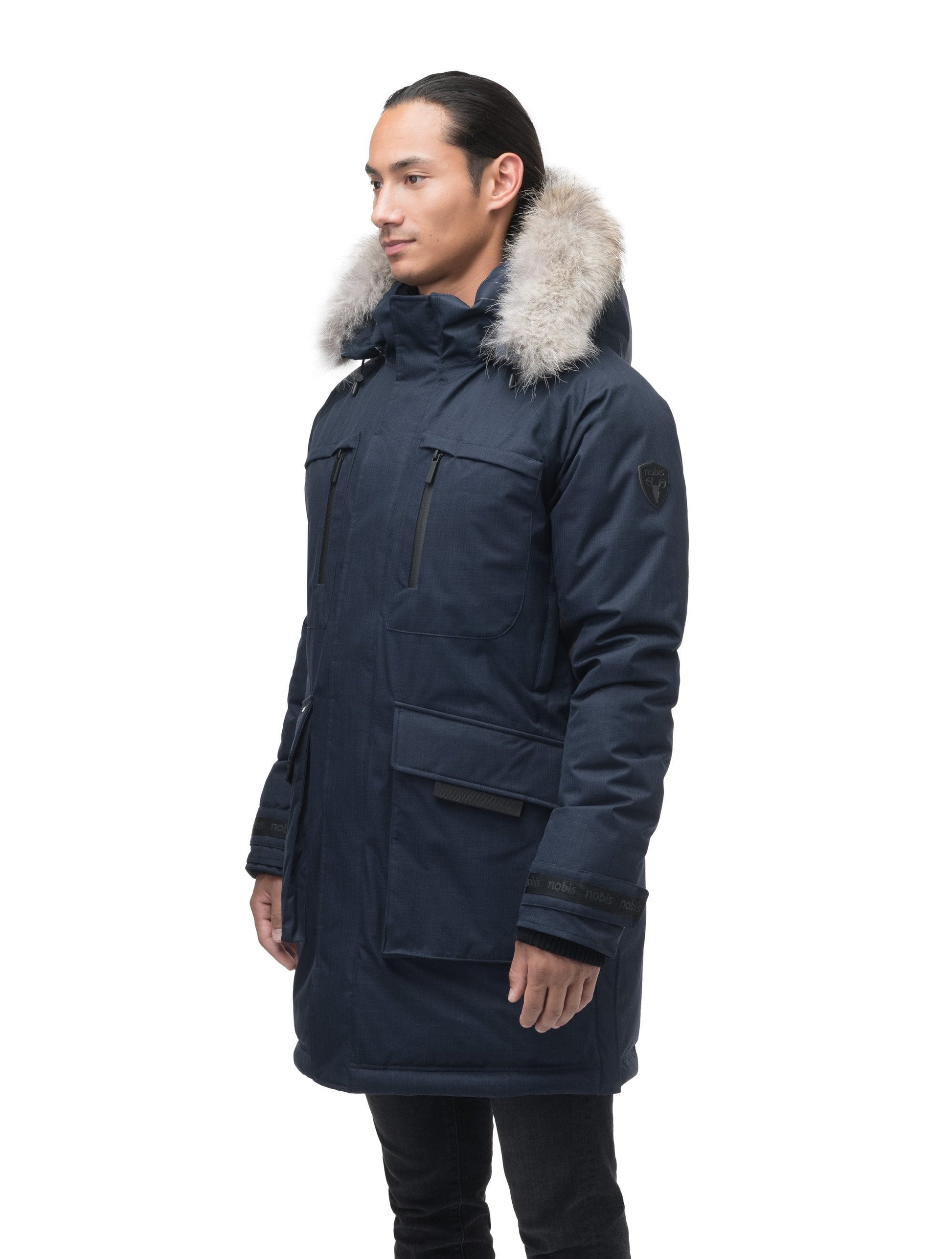 Men's thigh length down-filled parka with removable hood and removable coyote fur trim in Navy