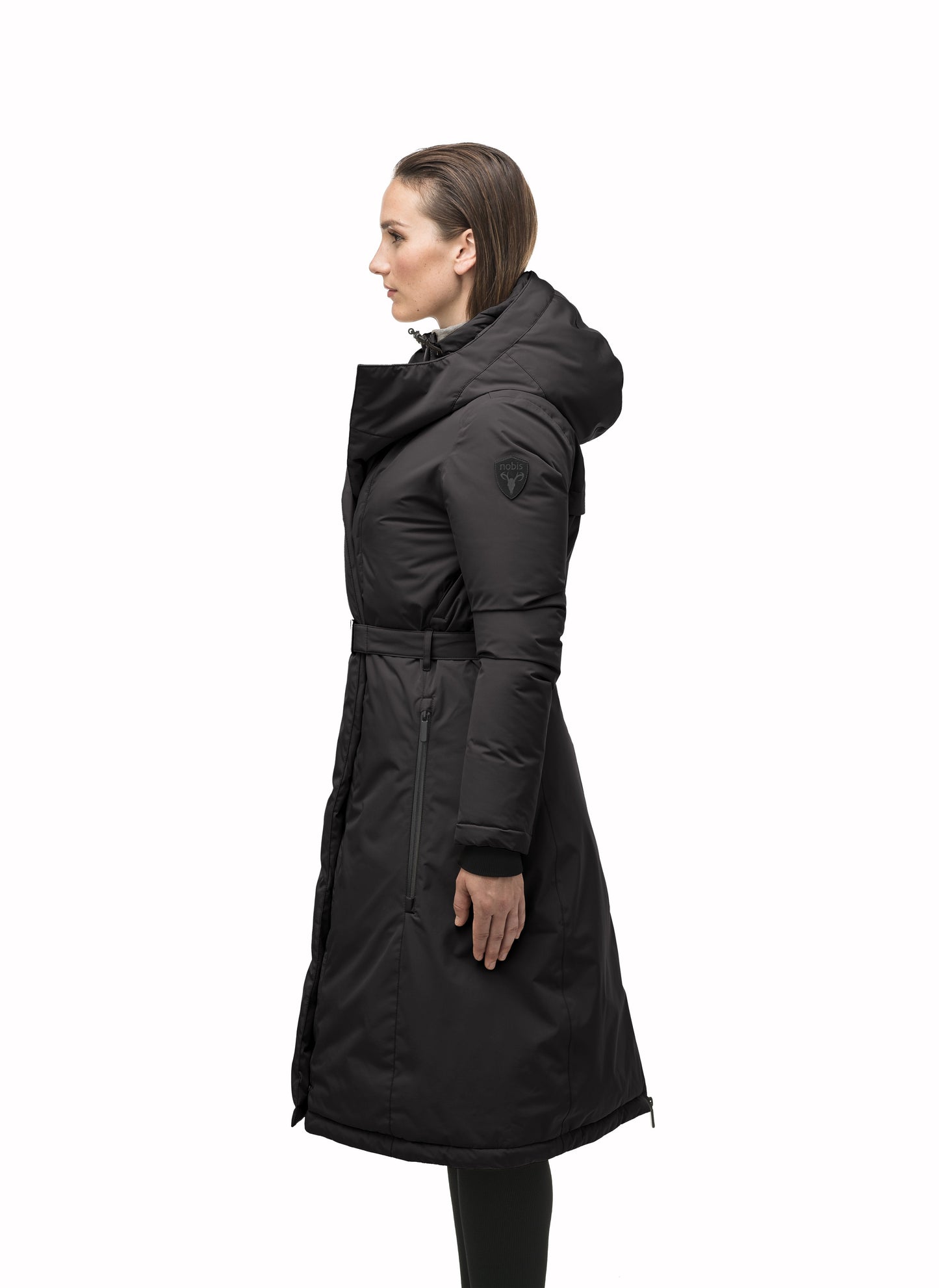 Long calf length hooded women's winter parka with an inner hip length closure, exterior hem length zipper and magentic placket in Black