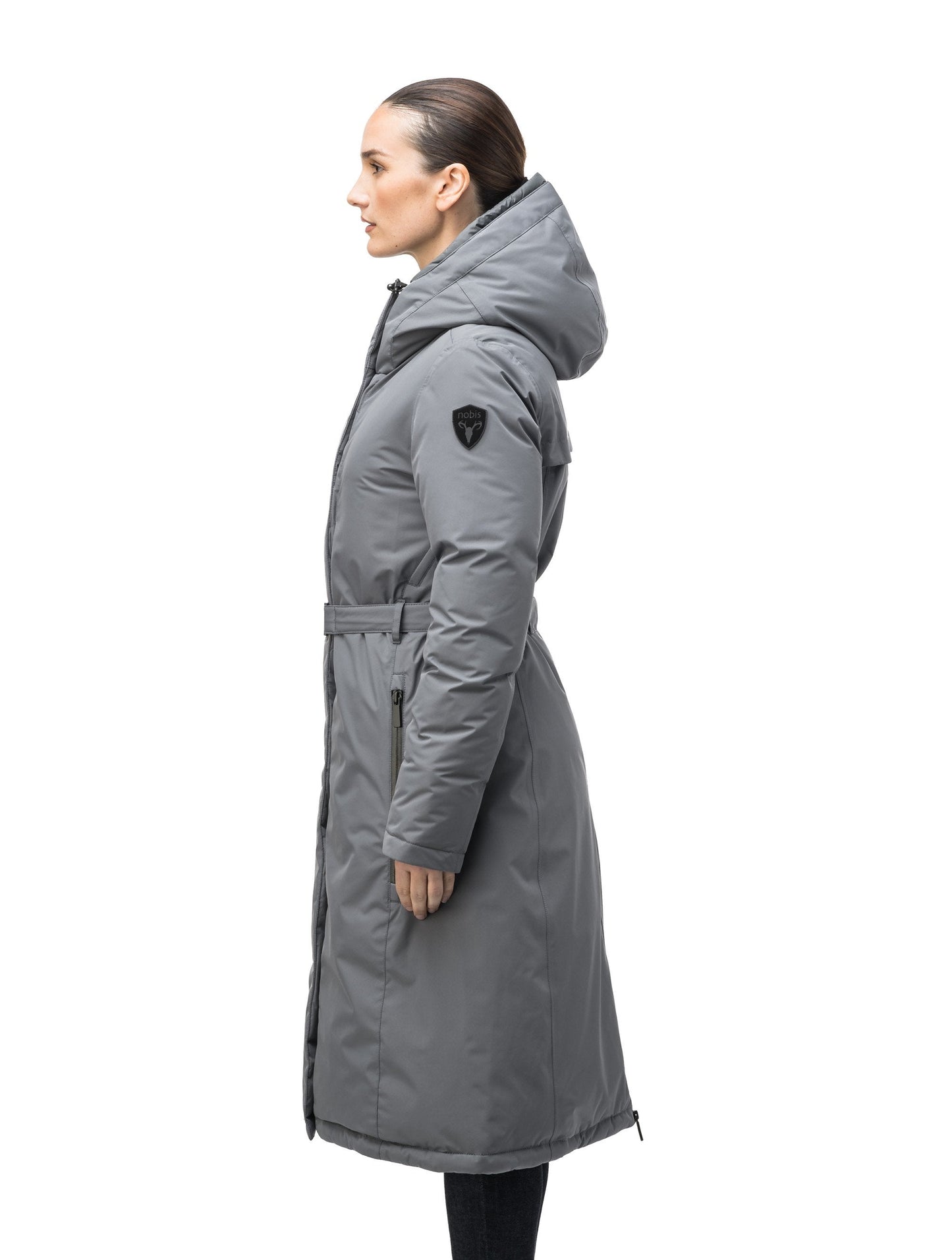 Long calf length hooded women's winter parka with an inner hip length closure, exterior hem length zipper and magentic placket in Concrete