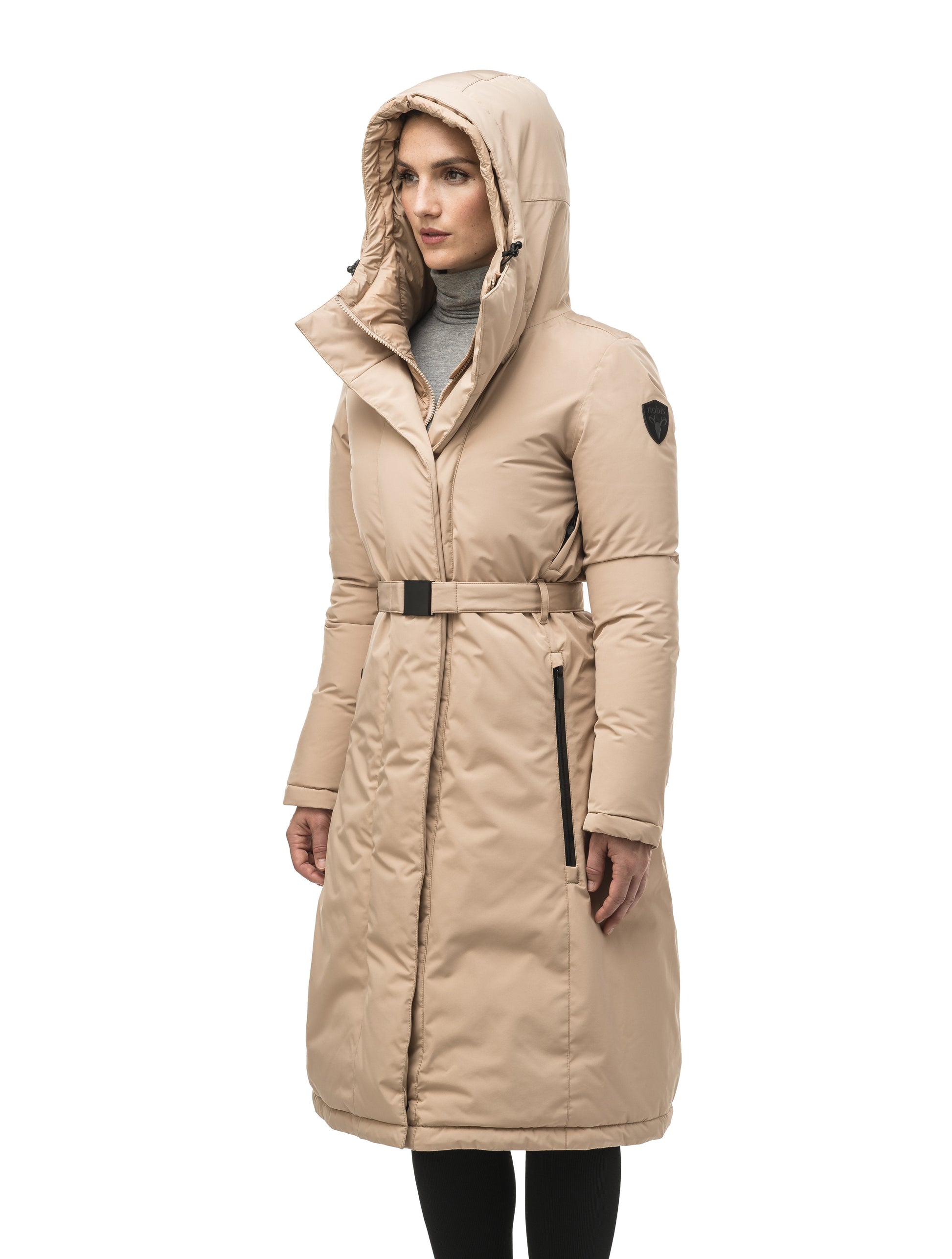 Long calf length hooded women's winter parka with an inner hip length closure, exterior hem length zipper and magentic placket in Fawn