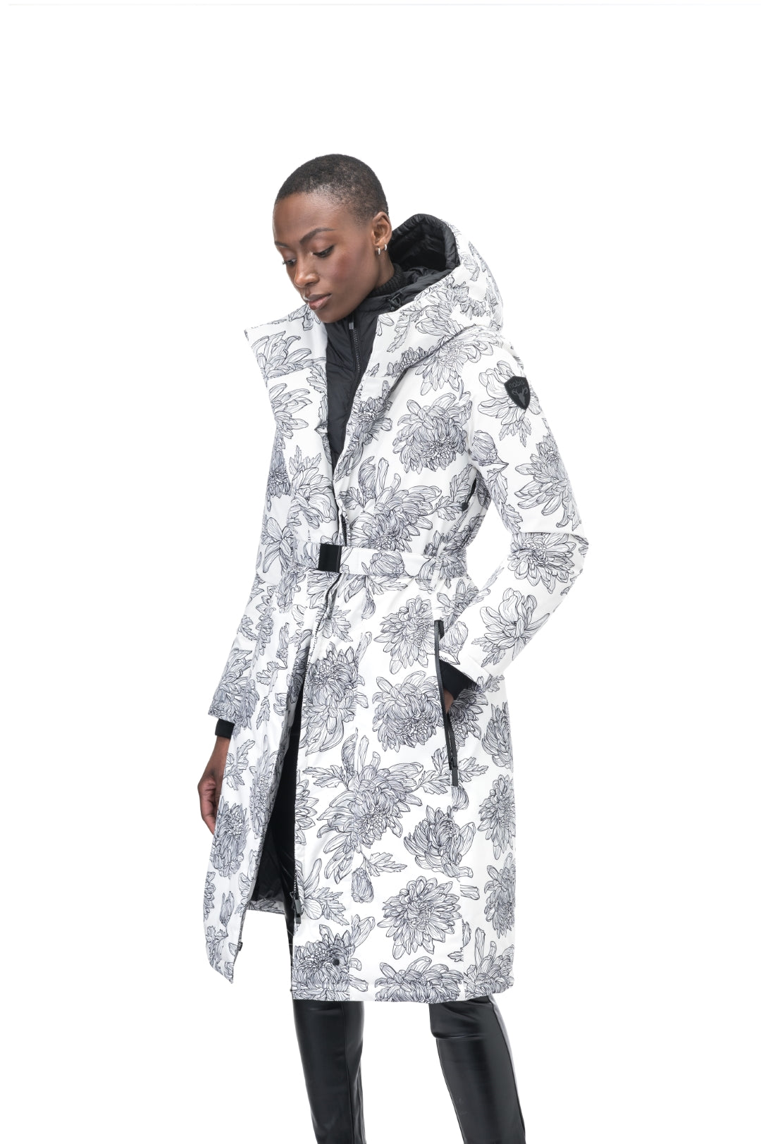 Long calf length hooded women's winter parka with an inner hip length closure, exterior hem length zipper and magnetic placket in White Floral