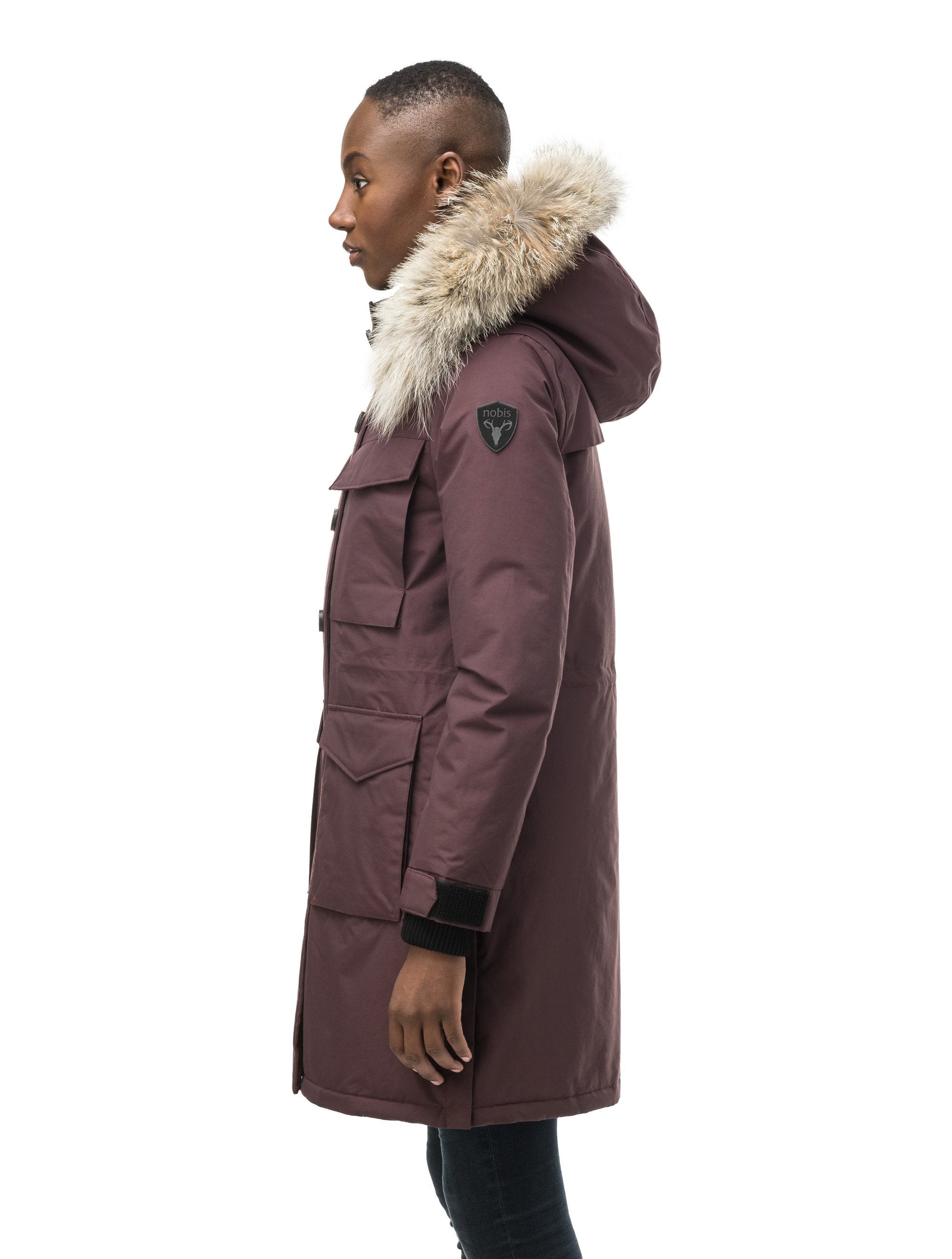 Women's knee length down filled parka with two chest patch pockets and two waist patch pockets in Burgundy