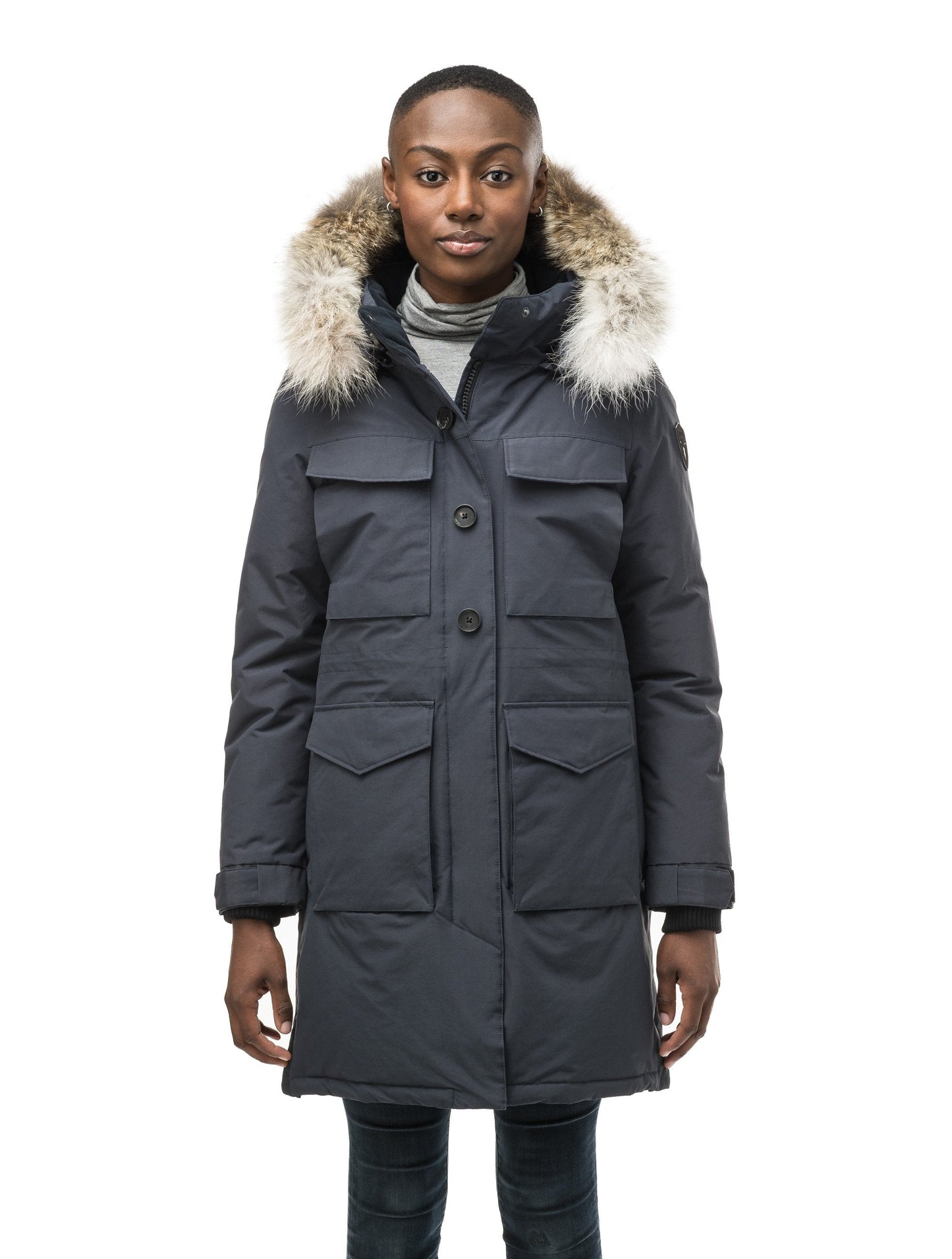 Women's knee length down filled parka with two chest patch pockets and two waist patch pockets in Navy