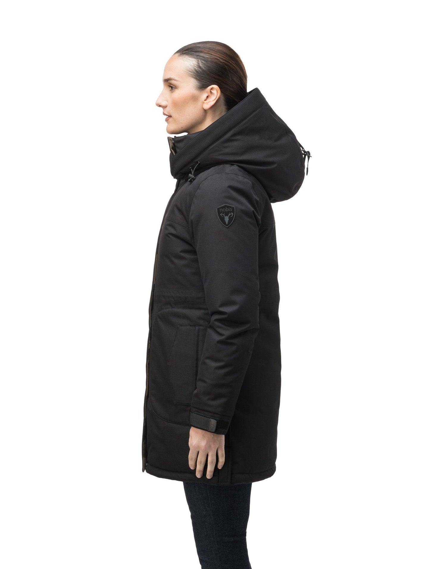 Thigh length women's down filled parka with side entry pockets and drawcord waist, removable hood and fur trim in Black