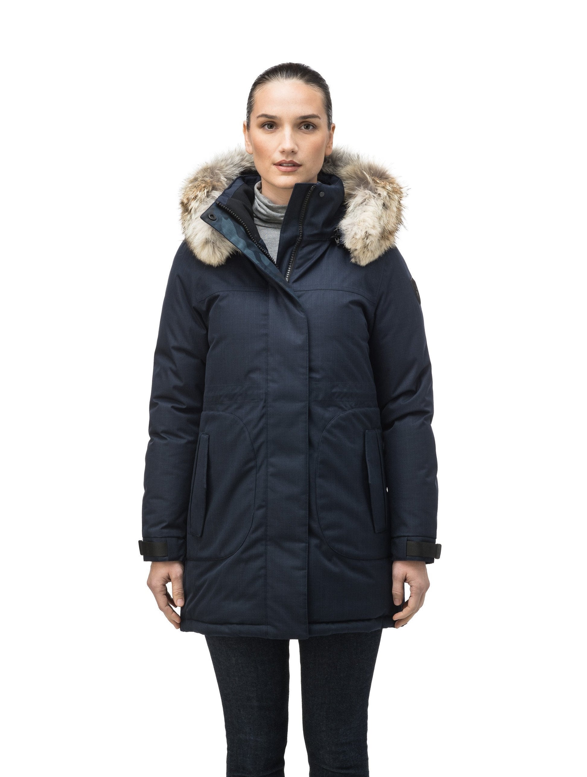 Thigh length women's down filled parka with side entry pockets and drawcord waist, removable hood and fur trim in Navy