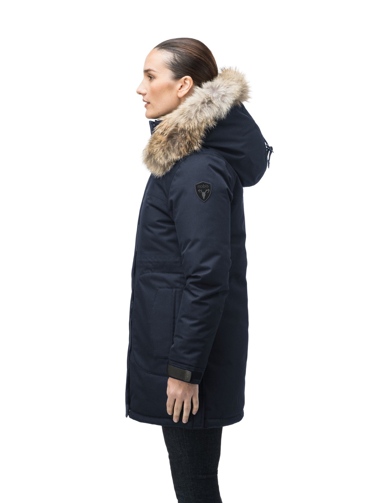 Thigh length women's down filled parka with side entry pockets and drawcord waist, removable hood and fur trim in Navy