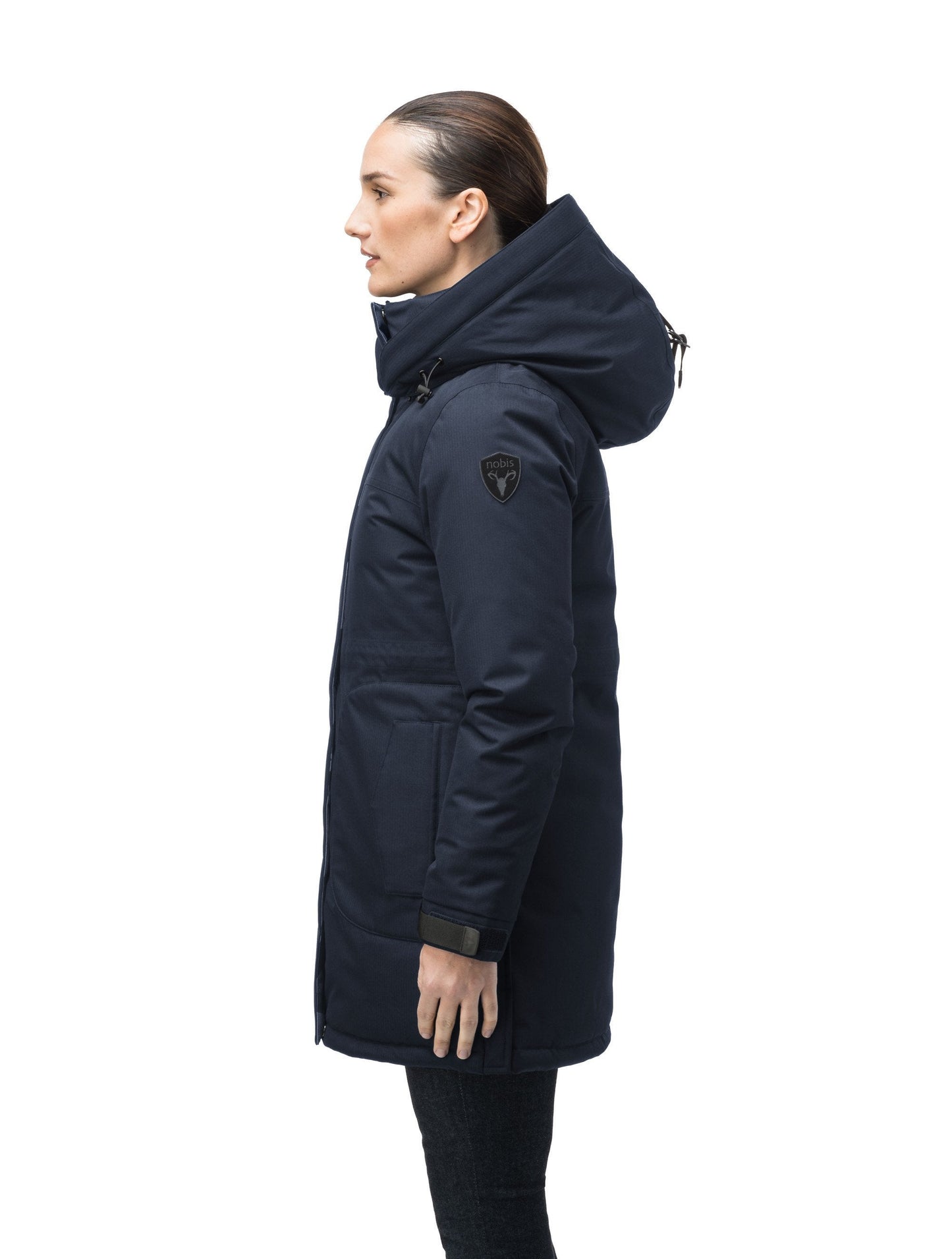 Thigh length women's down filled parka with side entry pockets and drawcord waist, removable hood and fur trim in Navy