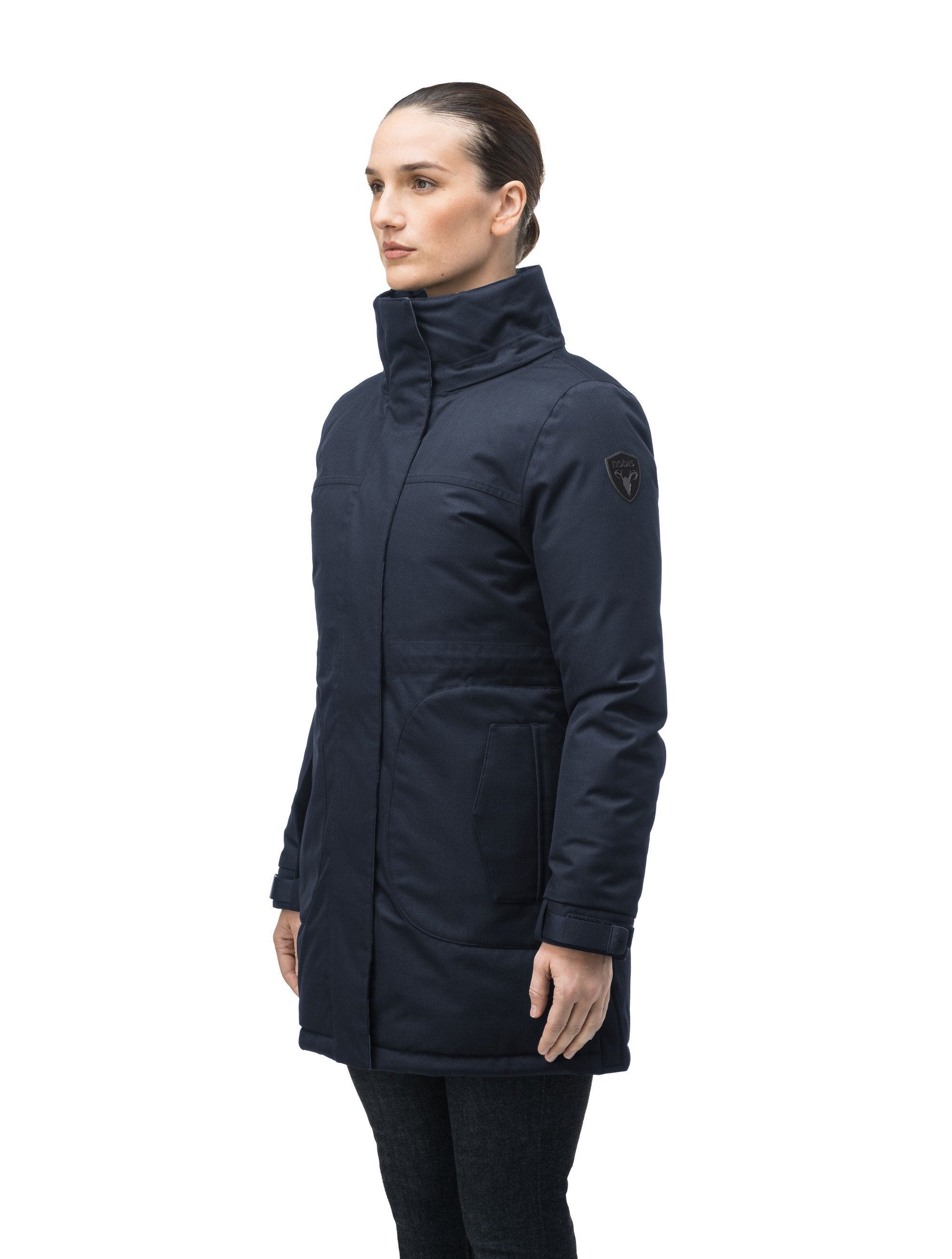 Thigh length women's down filled parka with side entry pockets and drawcord waist, removable hood and fur trim in Navy