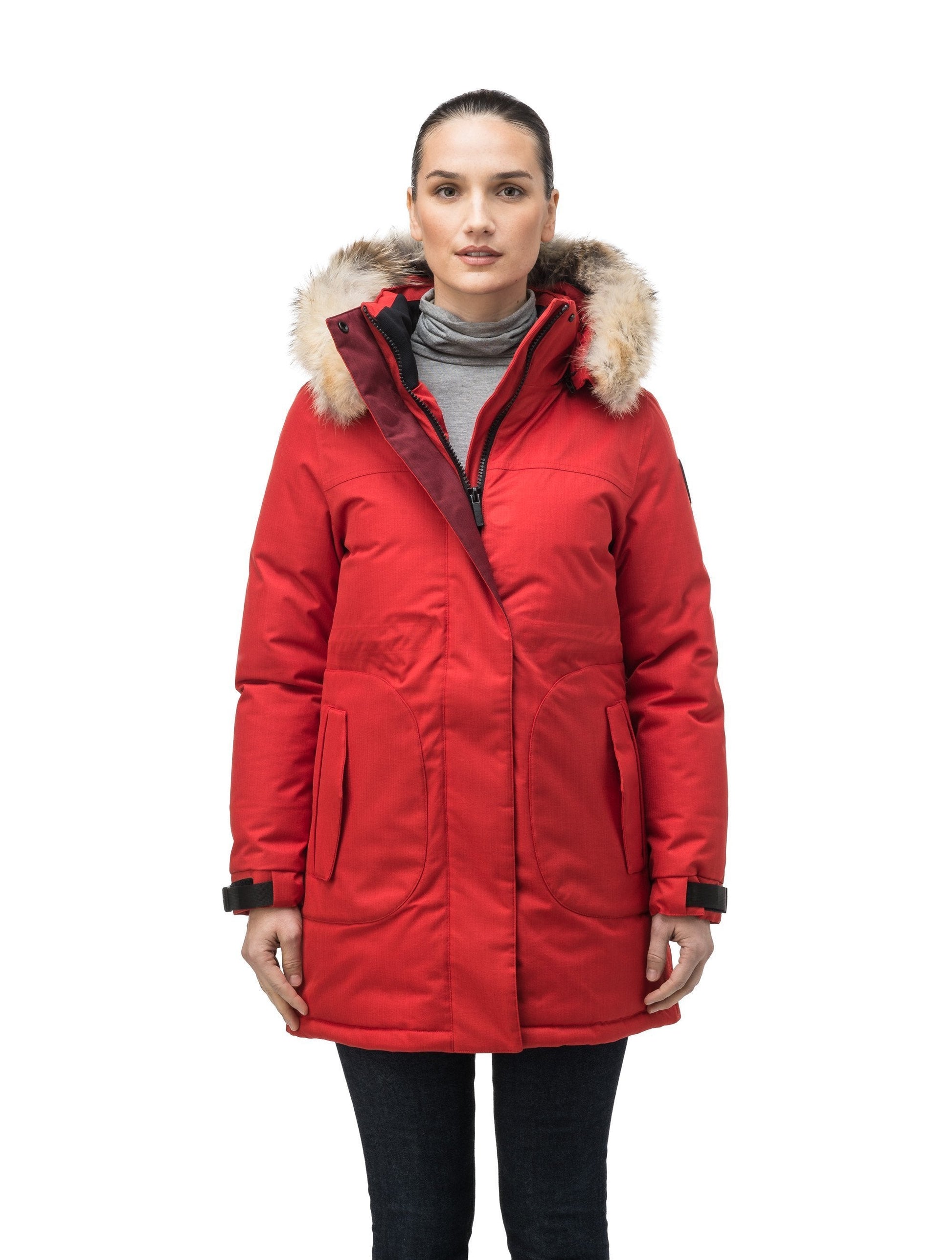 Thigh length women's down filled parka with side entry pockets and drawcord waist, removable hood and fur trim in Vermillion