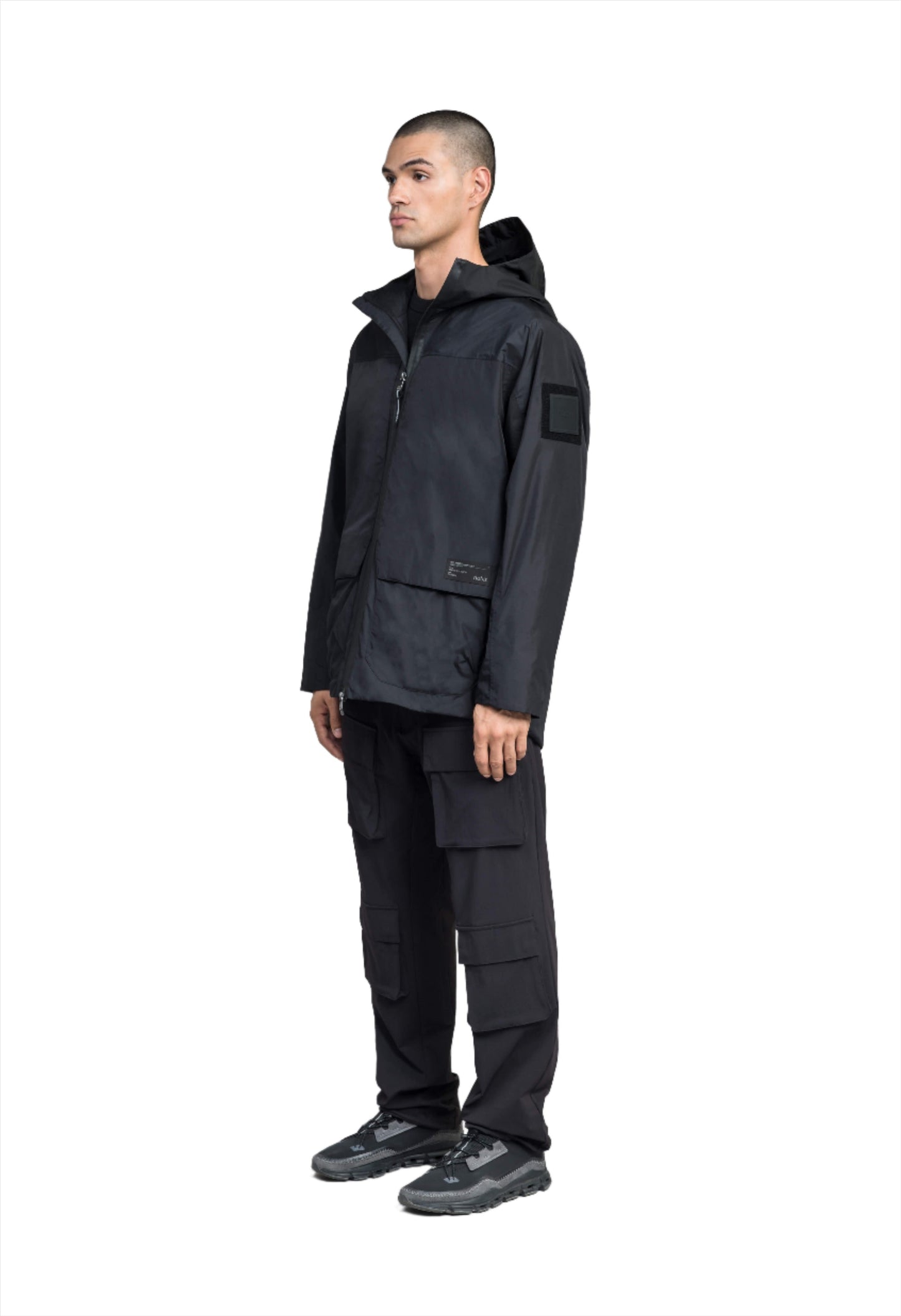 Mission Men's Performance Rain Shell Jacket in hip length, non-removable hood with adjustable toggle, two-way waterproof zipper, flap closure waist pockets with additional side entry storage, zipper ventilation on back, passive underarm ventilation, and breathable mesh lining, in Black