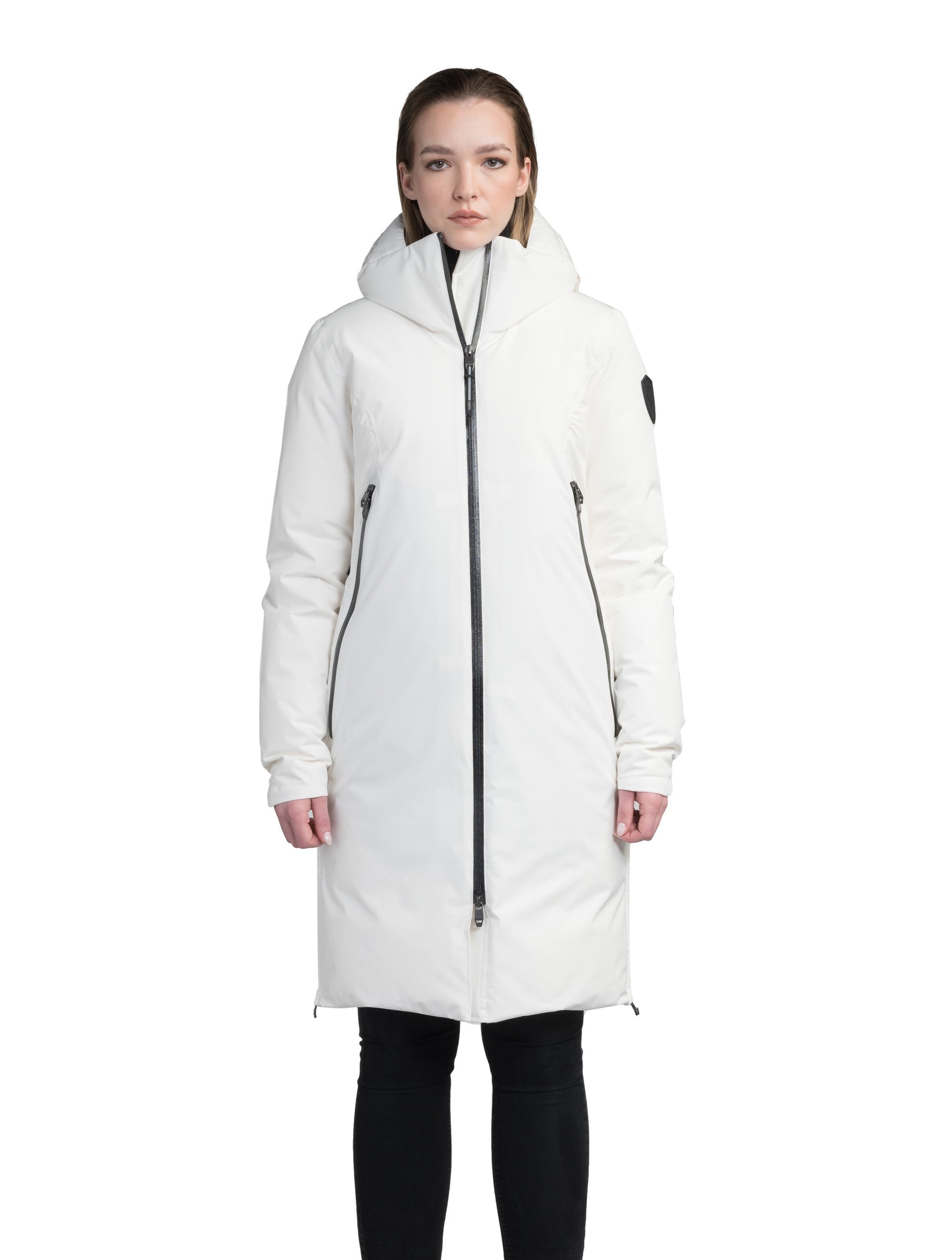 Inara Women's Performance Parka in knee length, premium 3-ply micro denier and stretch ripstop fabrication with DWR coating, Premium Canadian White Duck Down insulation, non-removable down-filled hood, centre front two-way zipper, large vertical zipper pockets along waist, zipper vents along bottom side hem, in Chalk