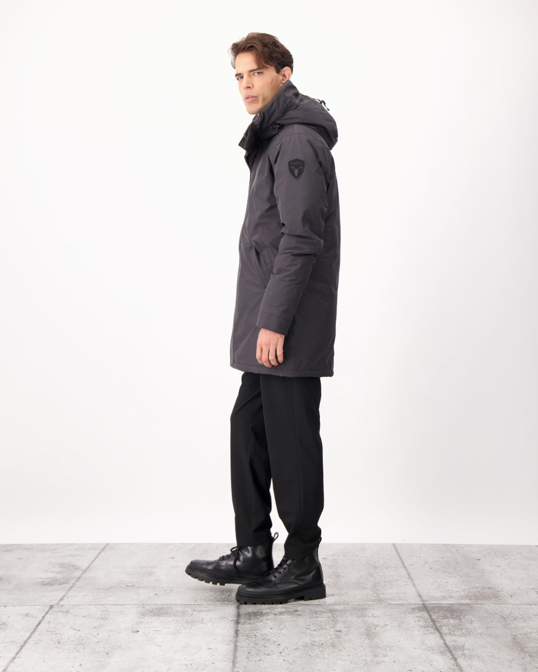 Pierre Men's Jacket in thigh length, Canadian white duck down insulation, non-removable down-filled hood, angled waist pockets, centre-front zipper with wind flap, and elastic ribbed cuffs, in 3L Black