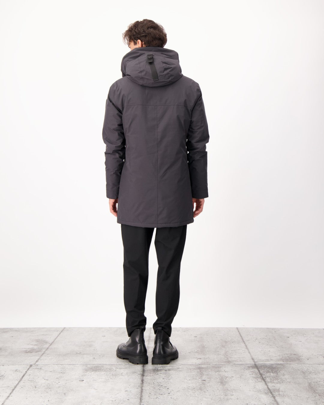 Pierre Men's Jacket in thigh length, Canadian white duck down insulation, non-removable down-filled hood, angled waist pockets, centre-front zipper with wind flap, and elastic ribbed cuffs, in 3L Black