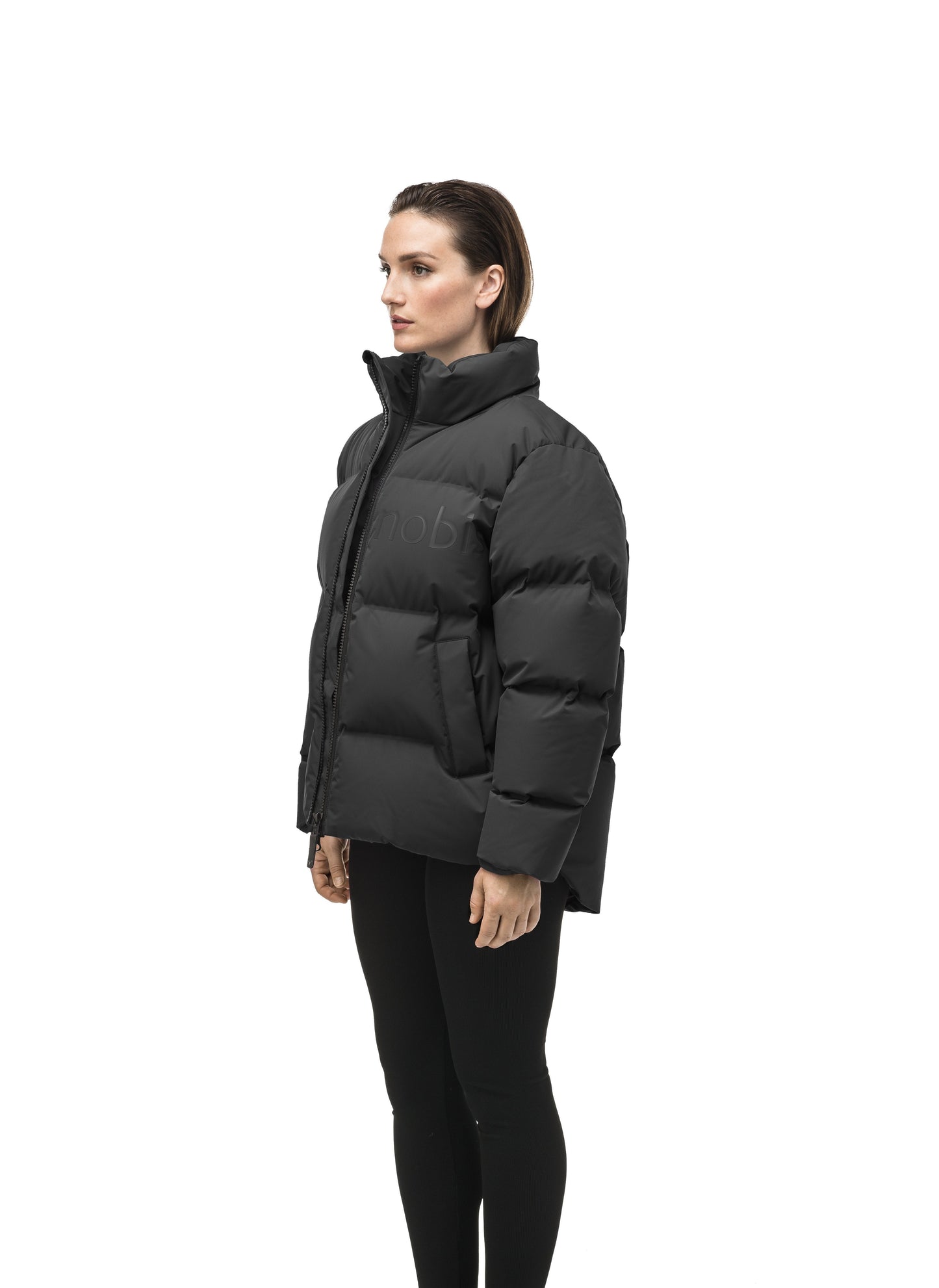 Women's puffer jacket with a minimalist modern design; featuring graphic details like oversized tonal branding, an exposed zipper, and seamless puffer channels to lock in the Premium Canadian Origin White Duck Down in Black