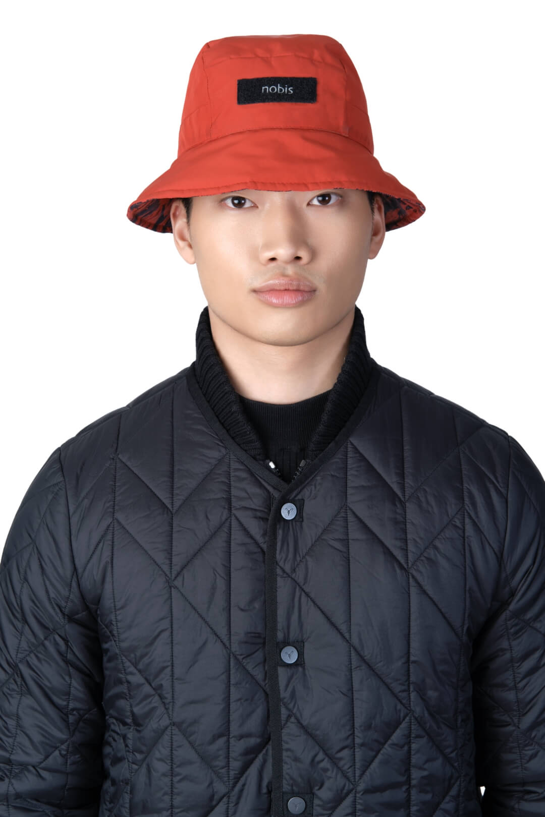 Lunar New Year Reversible Bucket Hat with one side in red tiger print, and the reverse side in tonal red with Nobis label branding on the crown front, in Vermillion