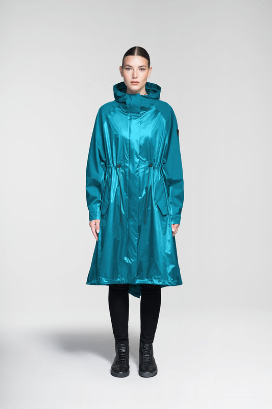Reyna Women's Tailored Packable Long Shell Jacket in knee length, premium strech ripstop and contrast cire technical nylon taffeta fabrication, non-removable hood with adjustable draw cord, waist flap pockets with magnetic closures, adjustable draw cords at waist and bottom hem, adjustable snap cuffs, mesh back ventilation, hidden packable pocket, snap button wind flap, two-way branded zipper at centre front, adjustable snap button fishtail yoke at back, and large interior zipper pocket, in Deep Lake + Marine / XS