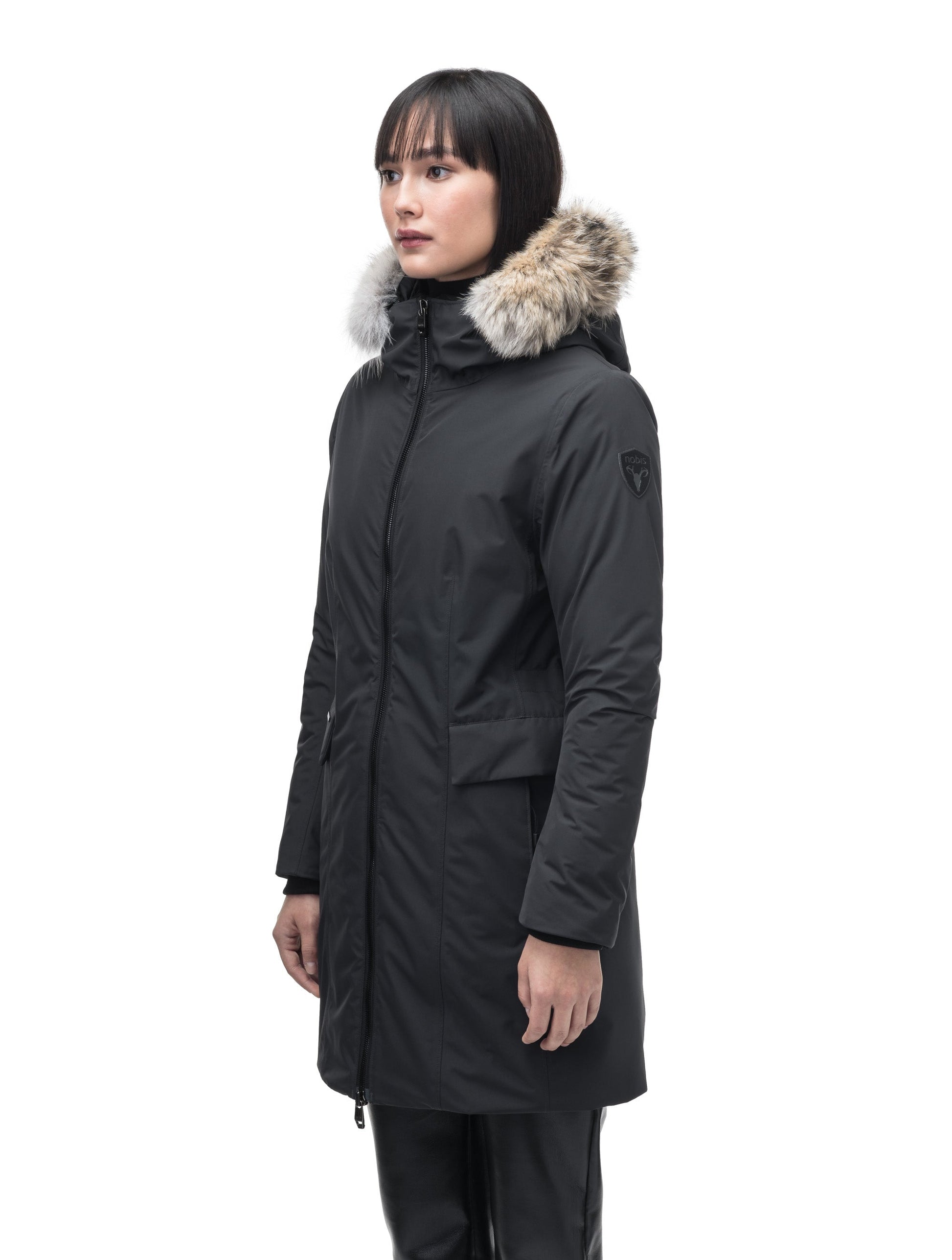 Romeda Ladies Mid Thigh Parka in thigh length, Canadian duck down insulation, non-removable hood with removable fur ruff trim, and two-way front zipper, in Black