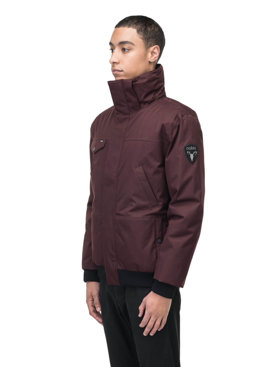 Men's sleek down filled bomber jacket with clean details and a fur free hood in Merlot