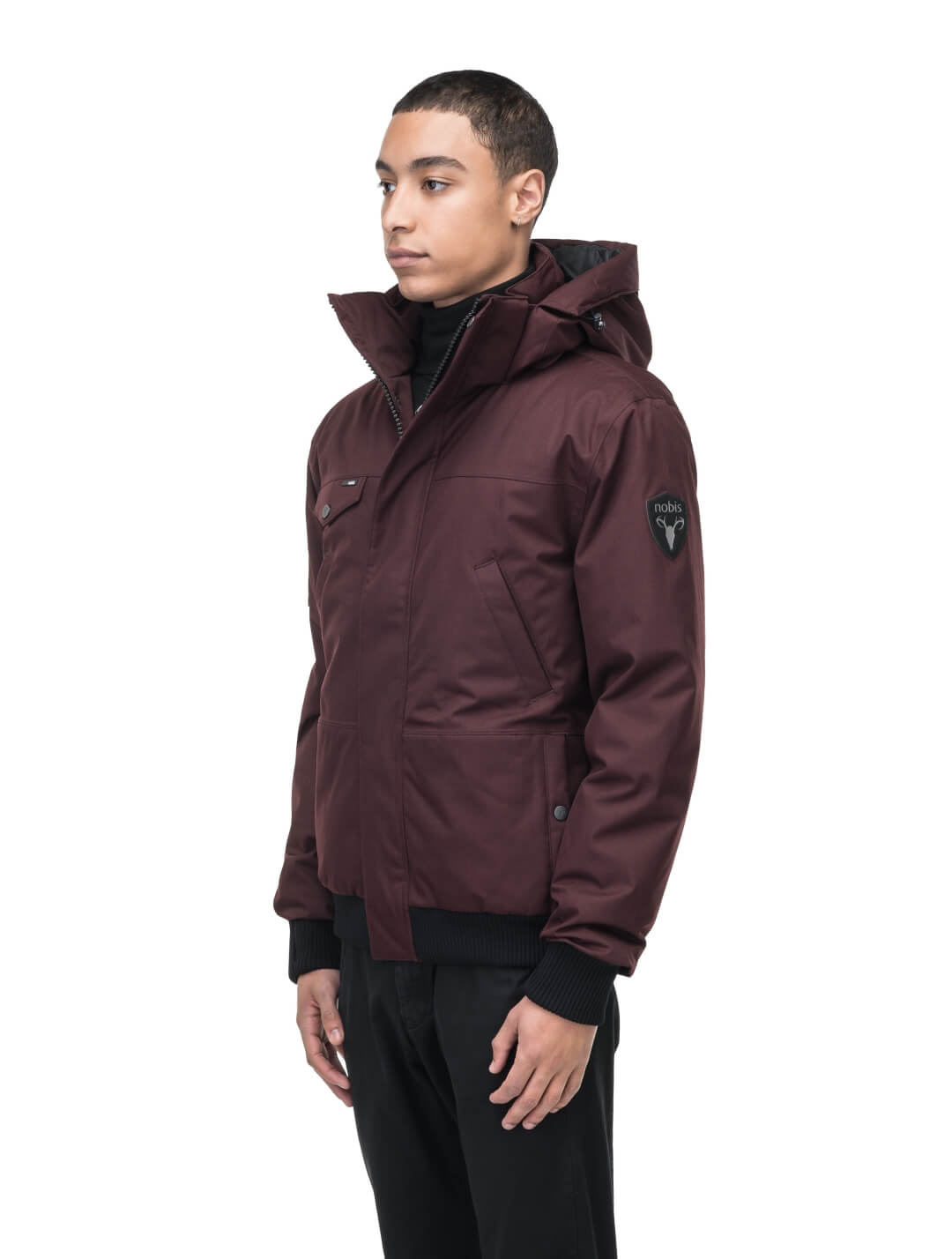 Men's sleek down filled bomber jacket with clean details and a fur free hood in Merlot